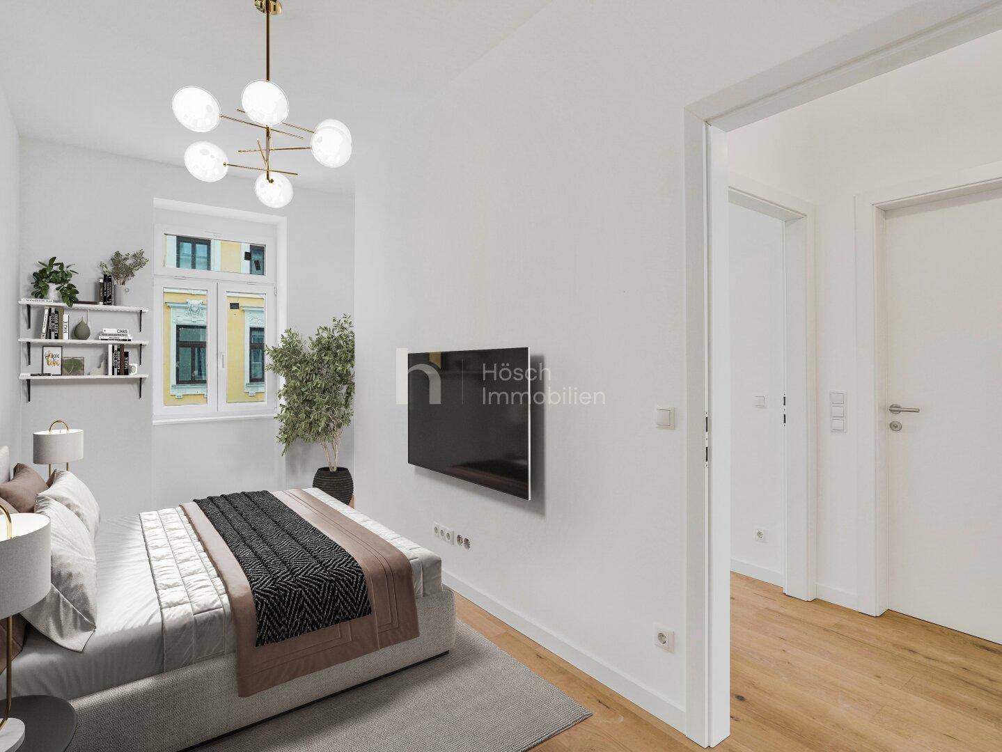 Schlafzimmer mit Wandfernseher, Holzboden und Blick auf die Umgebung, modern und funktional eingerichtet.