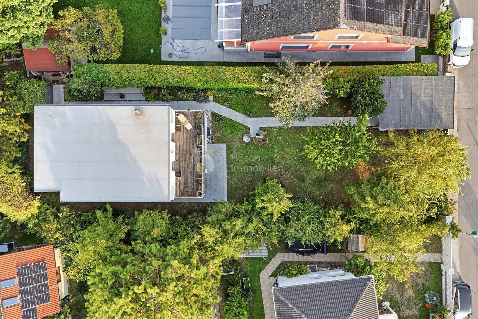 Draufsicht des Grundstücks mit Haus, Garten und angrenzenden Parzellen.