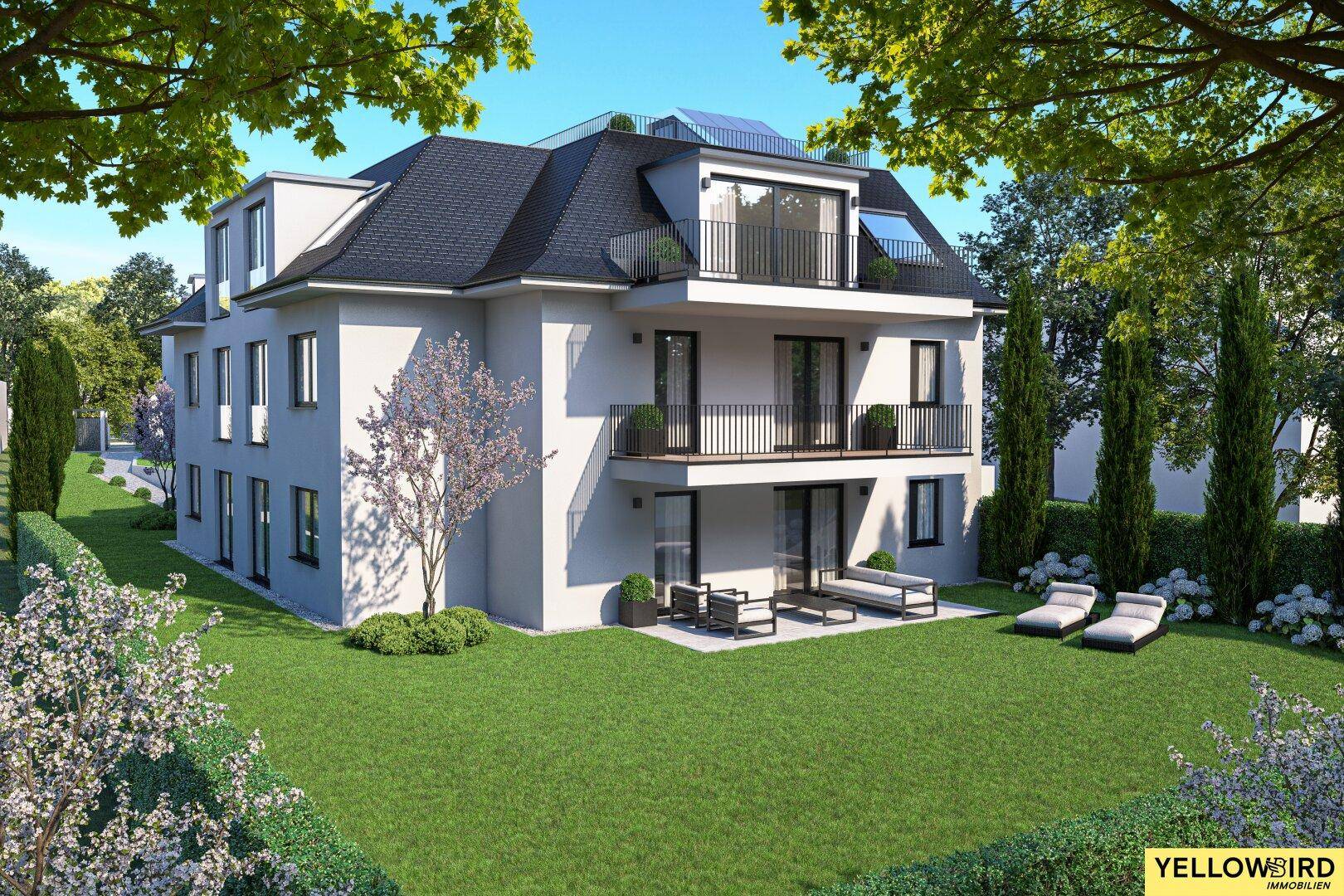 Attraktives Mehrfamilienhaus mit gepflegtem Garten, Balkonen und Terrassen in grüner Umgebung.