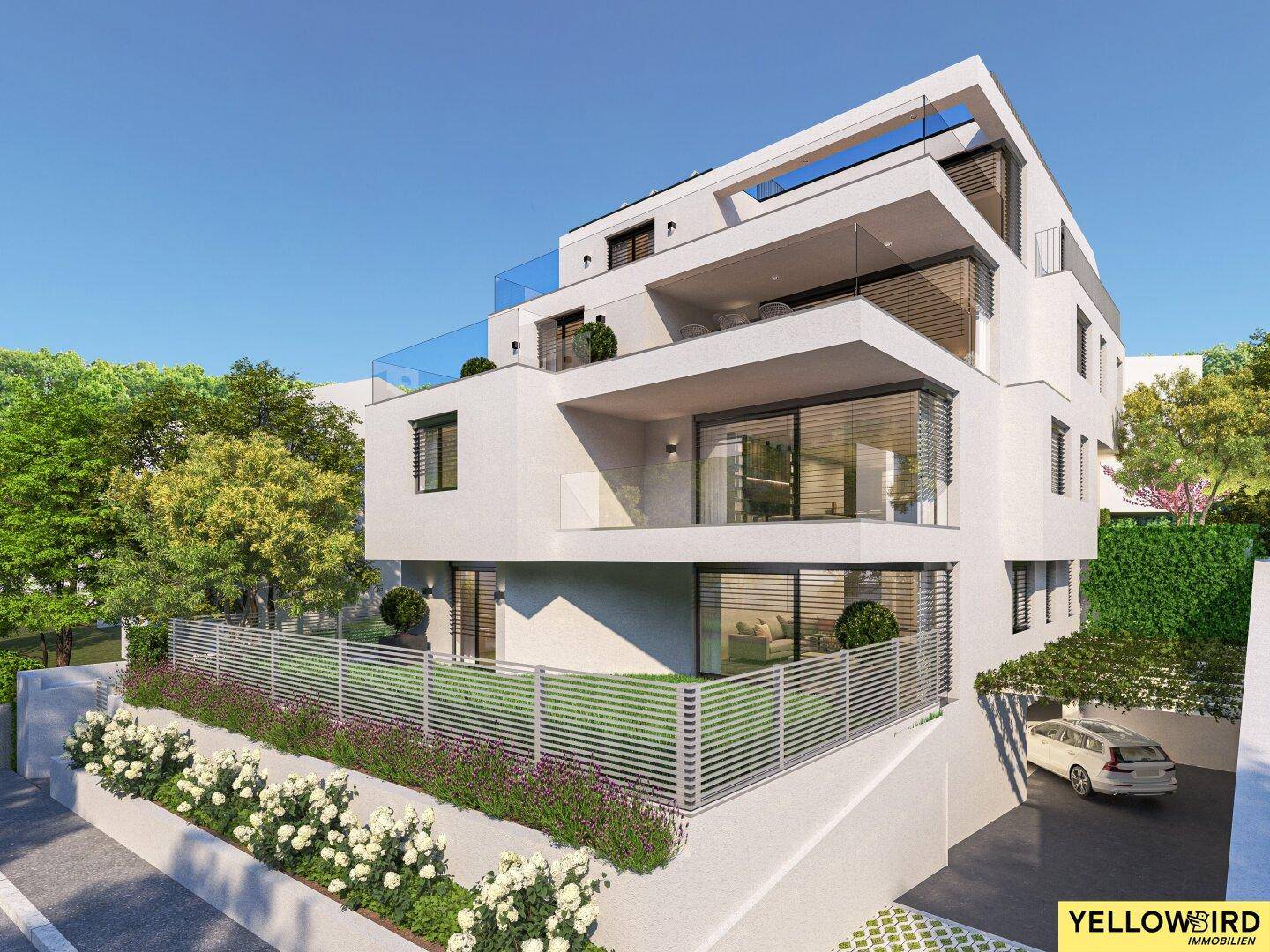 Moderne Architektur eines Mehrfamilienhauses mit Balkonen, Carport und grüner Umgebung.