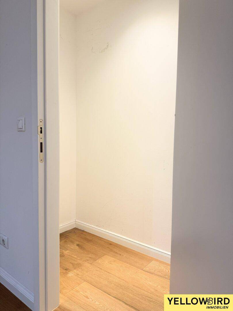 Kleiner Abstellraum mit Holzboden und weißen Wänden, ideal für zusätzlichen Stauraum.