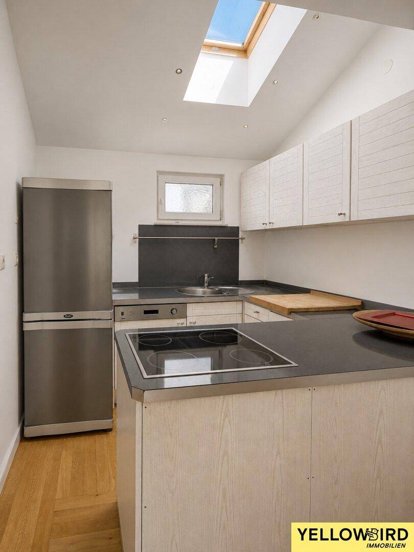 Gut ausgestattete Küche mit Kochfeld, Spülmaschine und Kühlschrank, ideal für den täglichen Gebrauch.
