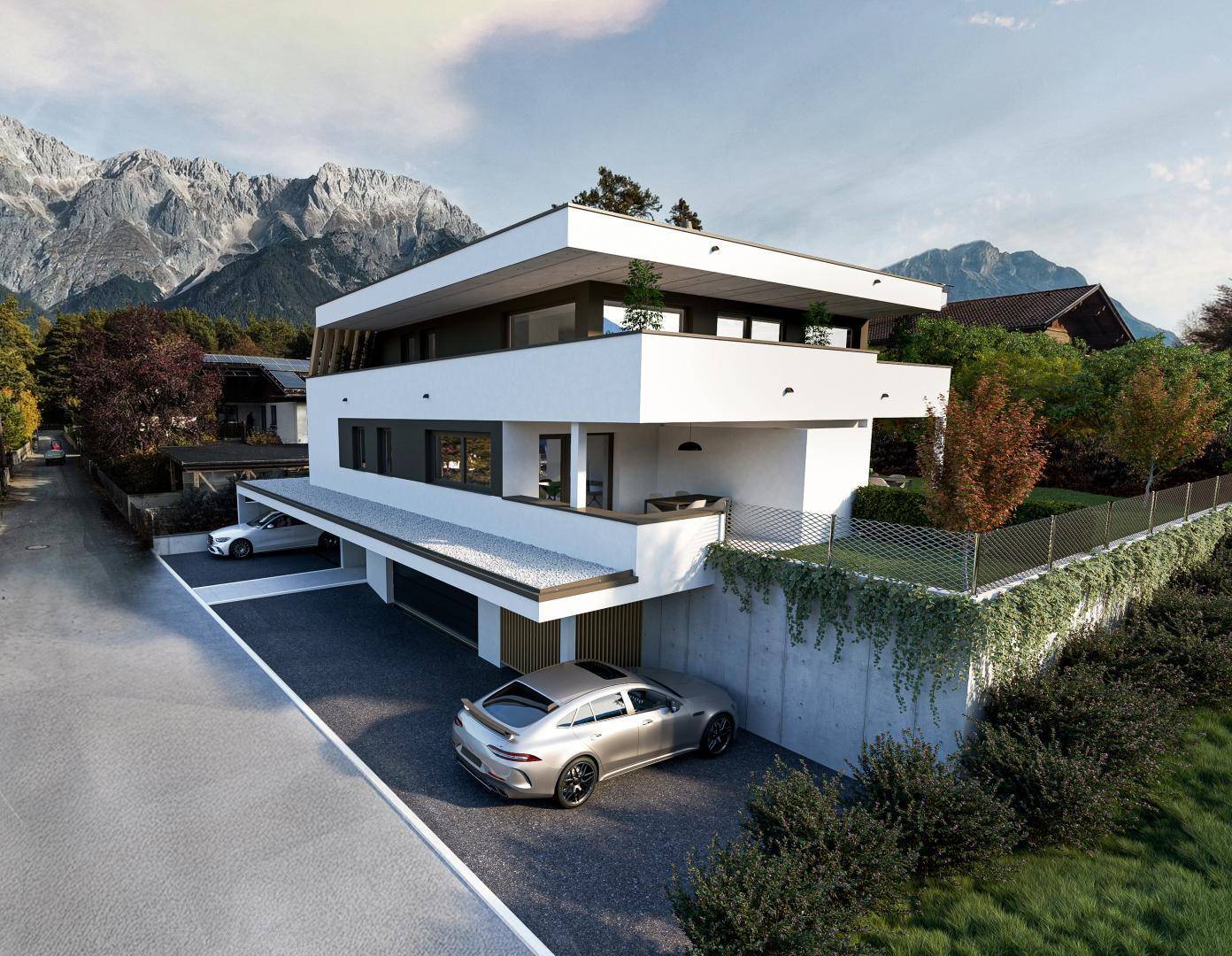 Moderne Wohnanlage mit Tiefgaragenzufahrt und beeindruckendem Bergblick in ruhiger Umgebung.