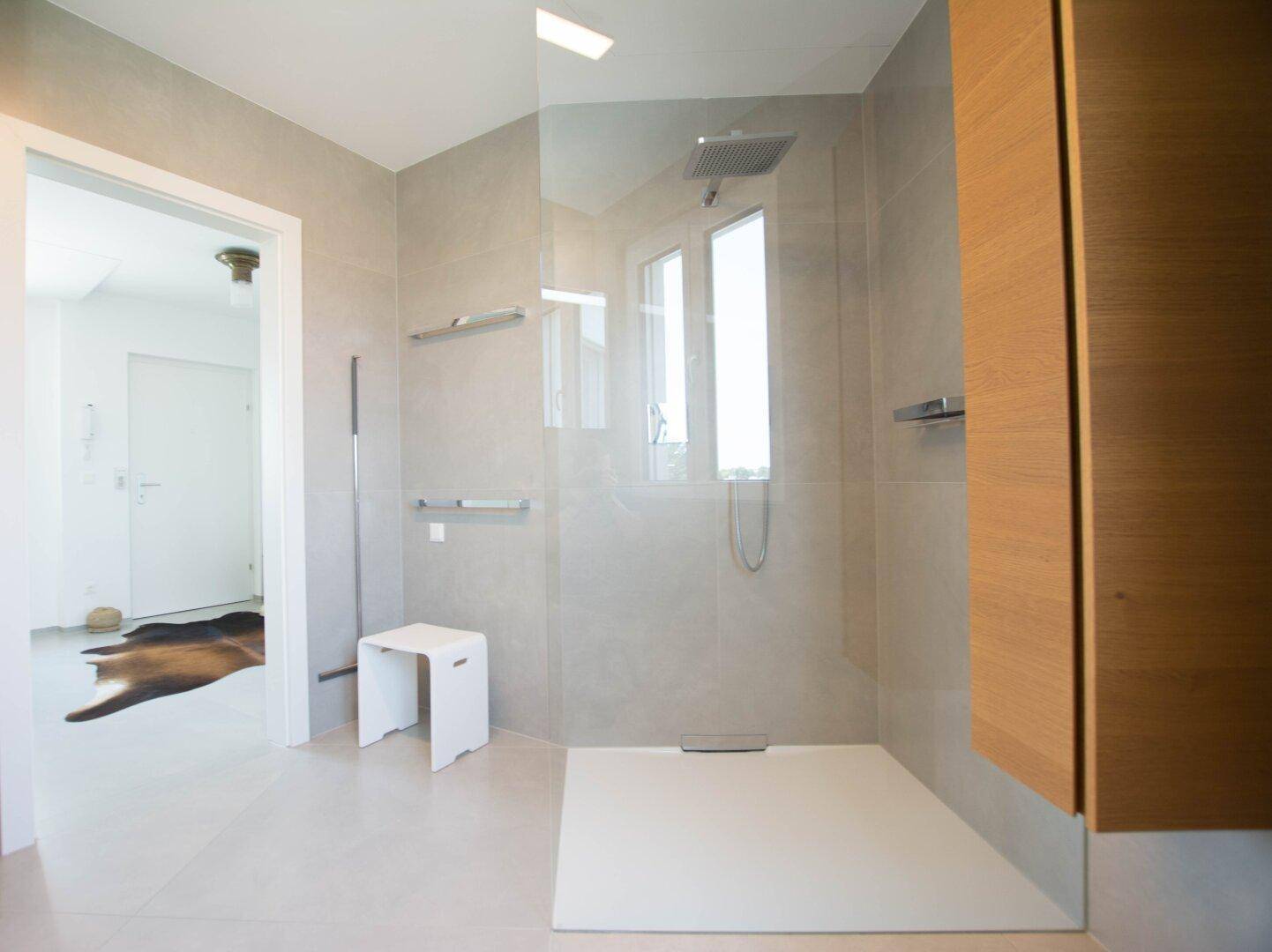 Modernes Badezimmer mit großer, begehbarer Dusche und Regendusche.