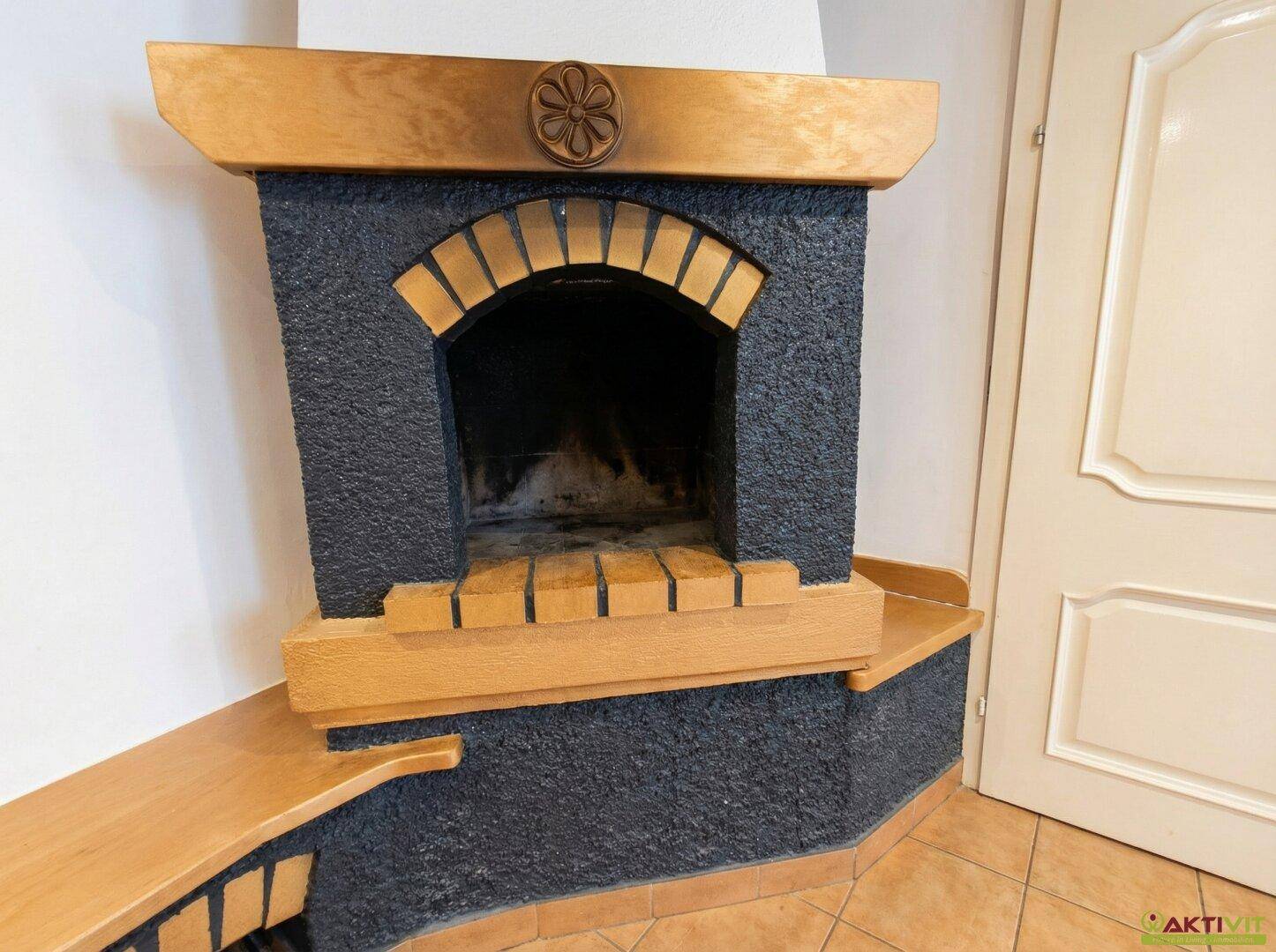 Gemütlicher Kamin mit Holzlager und traditionellen Ziegelakzenten.