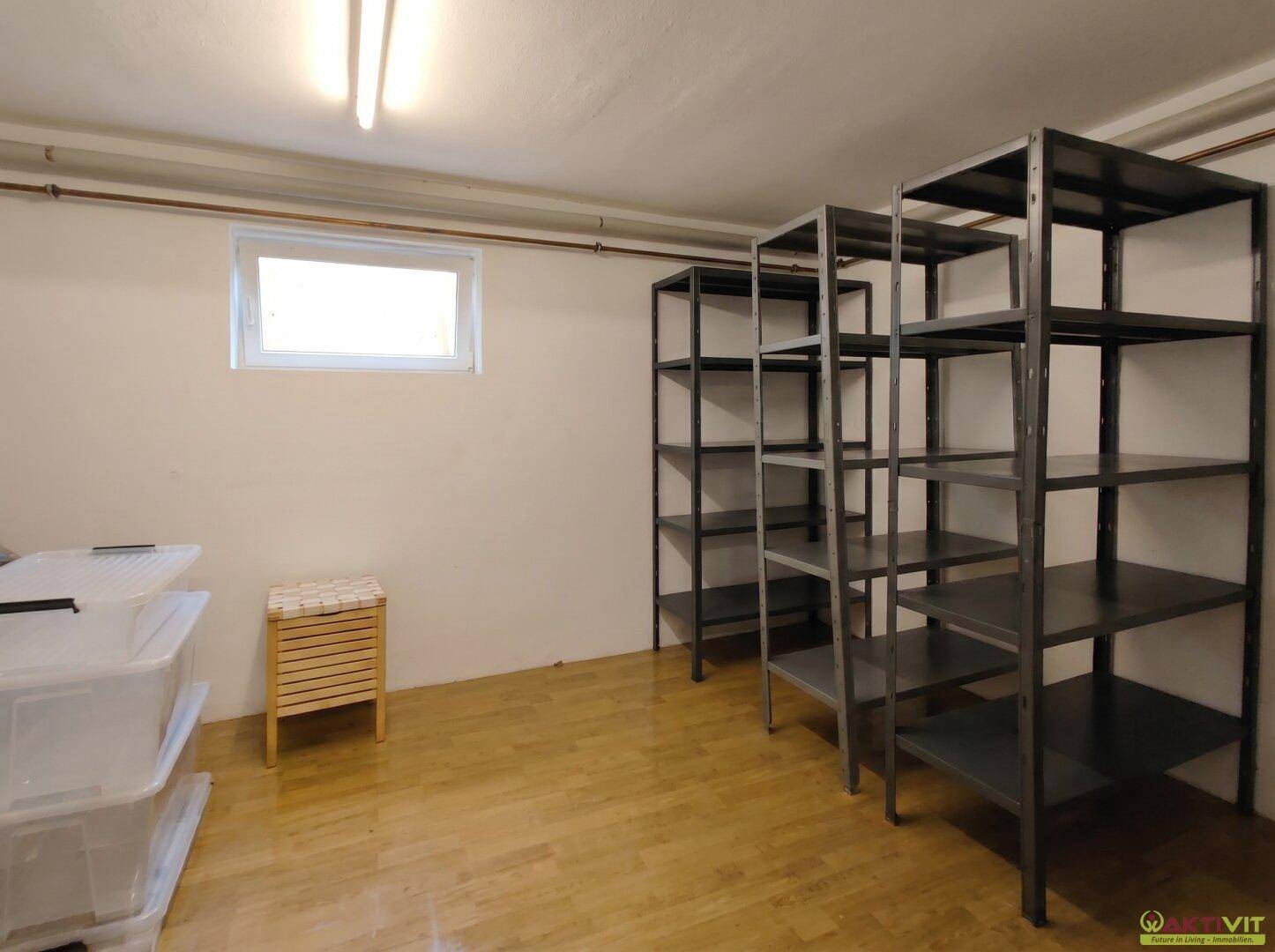 Kellerraum mit Regalen und kleinem Fenster, ideal für zusätzliche Lagerung.