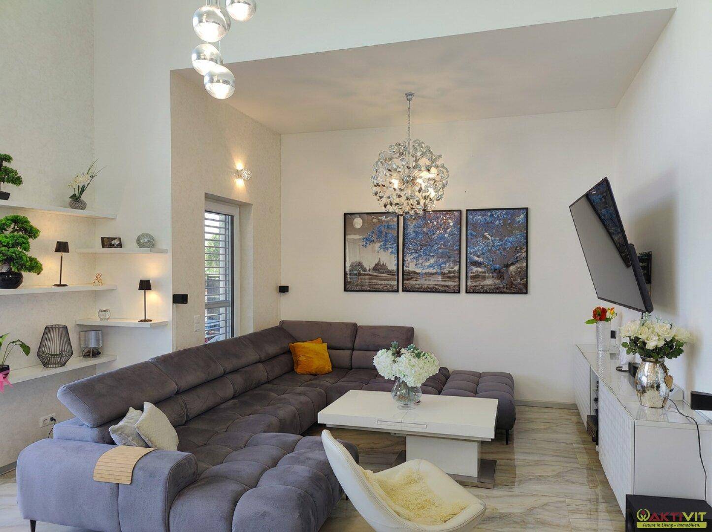 Modernes Wohnzimmer mit bequemer Couch, stilvoller Beleuchtung und Wanddekoration.