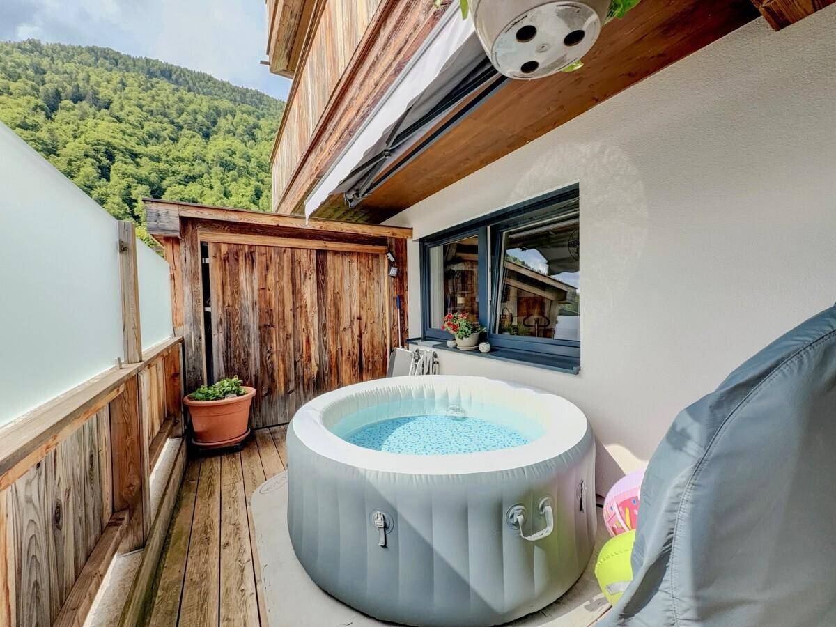 Balkon mit aufblasbarem Whirlpool und Blick auf die umliegende Berglandschaft.