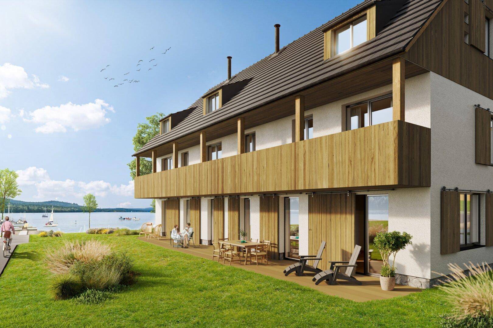 Rendering eines modernen Gebäudes mit Terrasse, Garten und direktem Seeblick.
