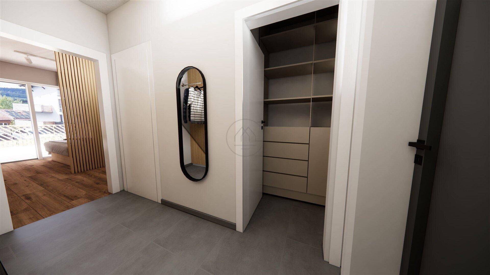 Heller Flur mit Einbauschrank und modernem Spiegel, führt zum Wohnbereich.