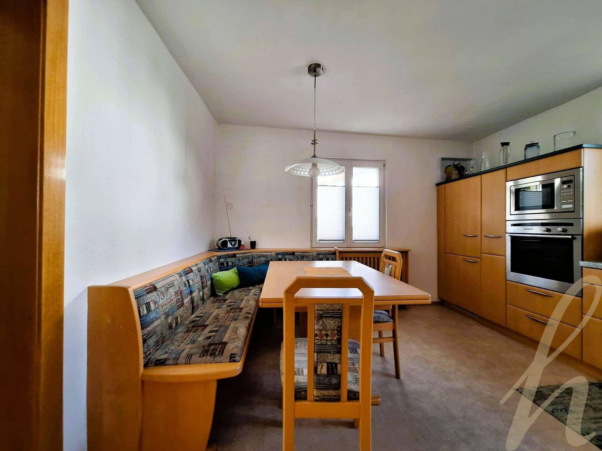Gemütlicher Essbereich in der Küche mit Eckbank und Holztisch.