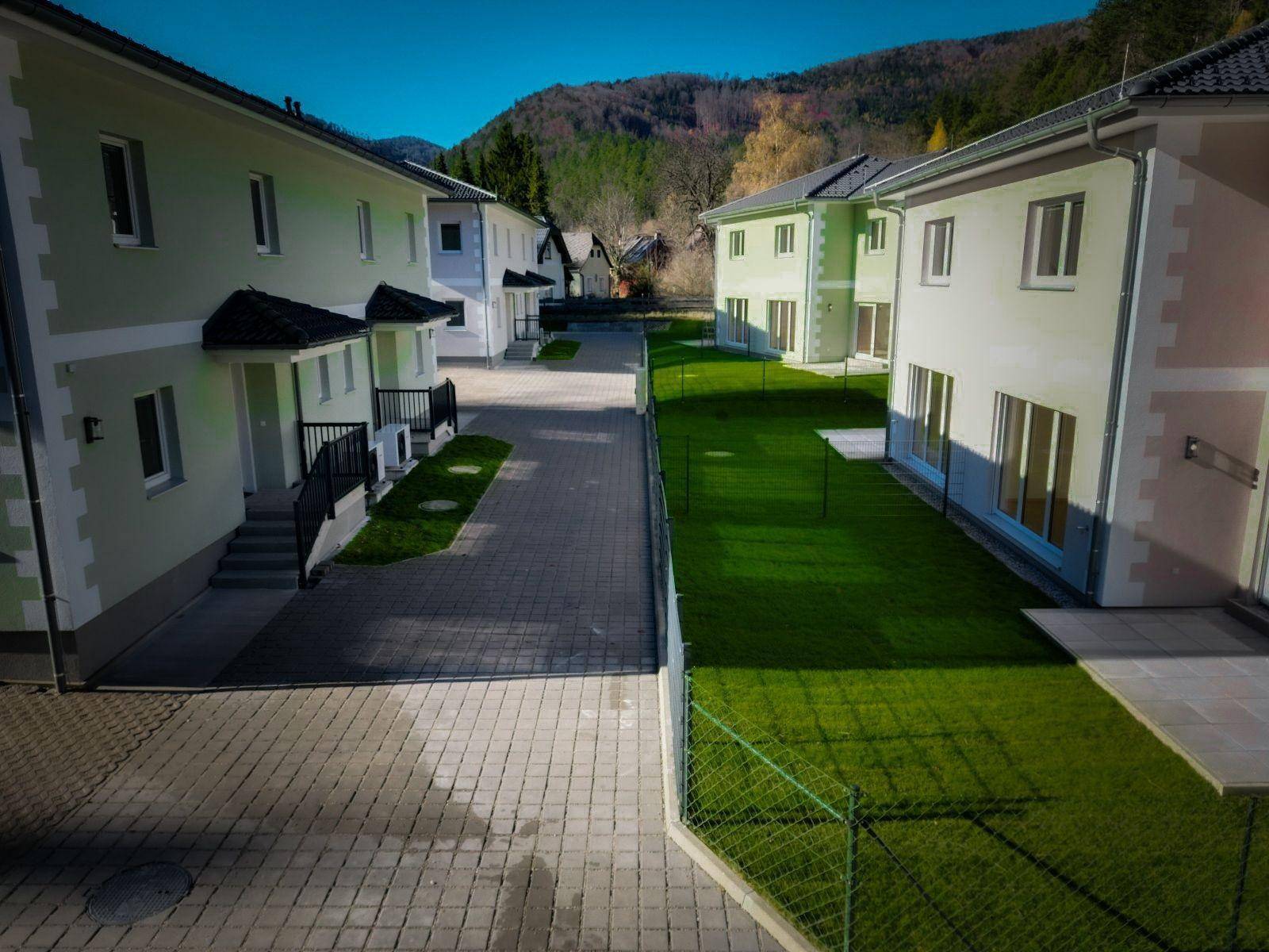 Reihen von modernen Einfamilienhäusern mit gepflasterten Zufahrten und grünen Vorgärten.