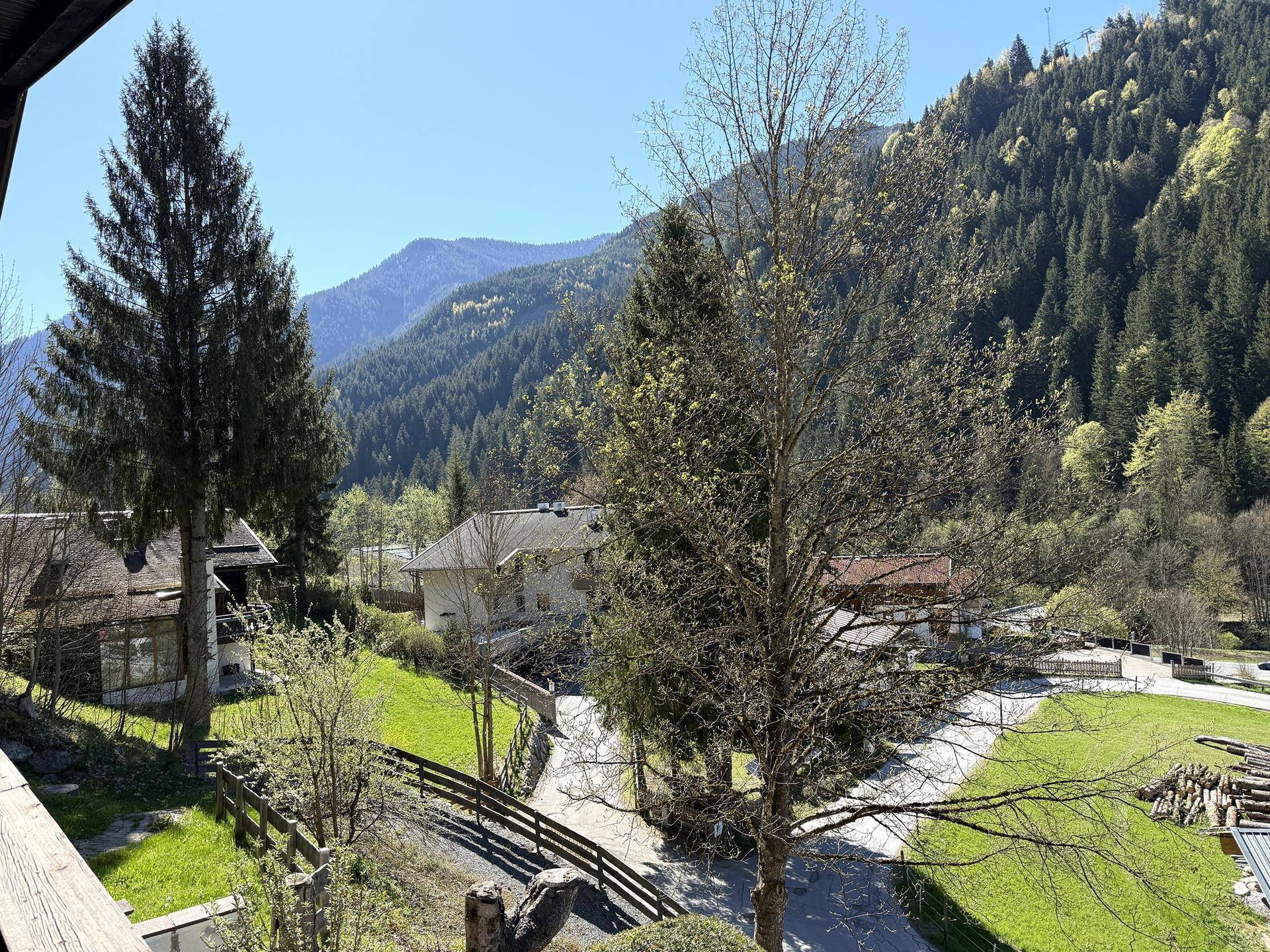 Panoramablick auf die umliegende Berglandschaft und grüne Wiesen von der Unterkunft aus.