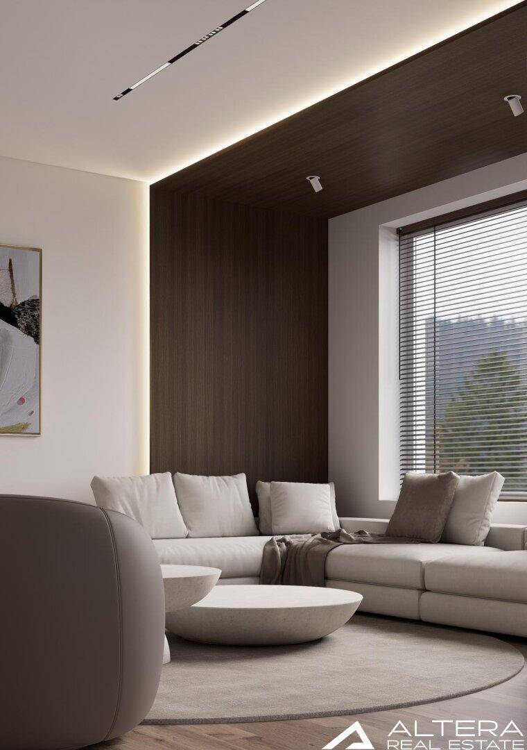 Gemütlicher Wohnbereich mit beigem Sofa, runden Couchtischen und indirekter Beleuchtung.