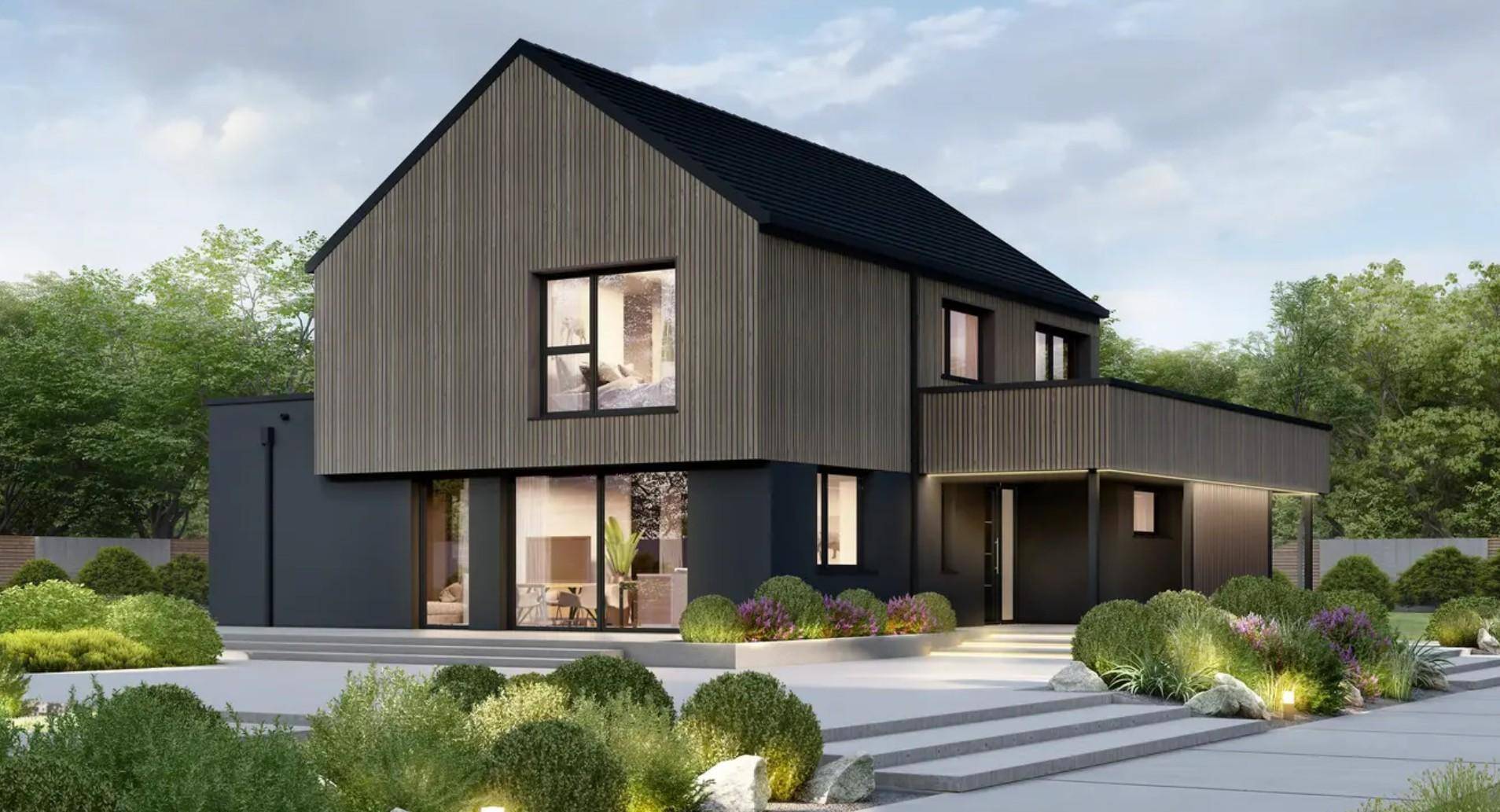 Modernes Haus mit dunkler Fassade, Holzverkleidung und großen Fenstern, umgeben von grünen Büschen.