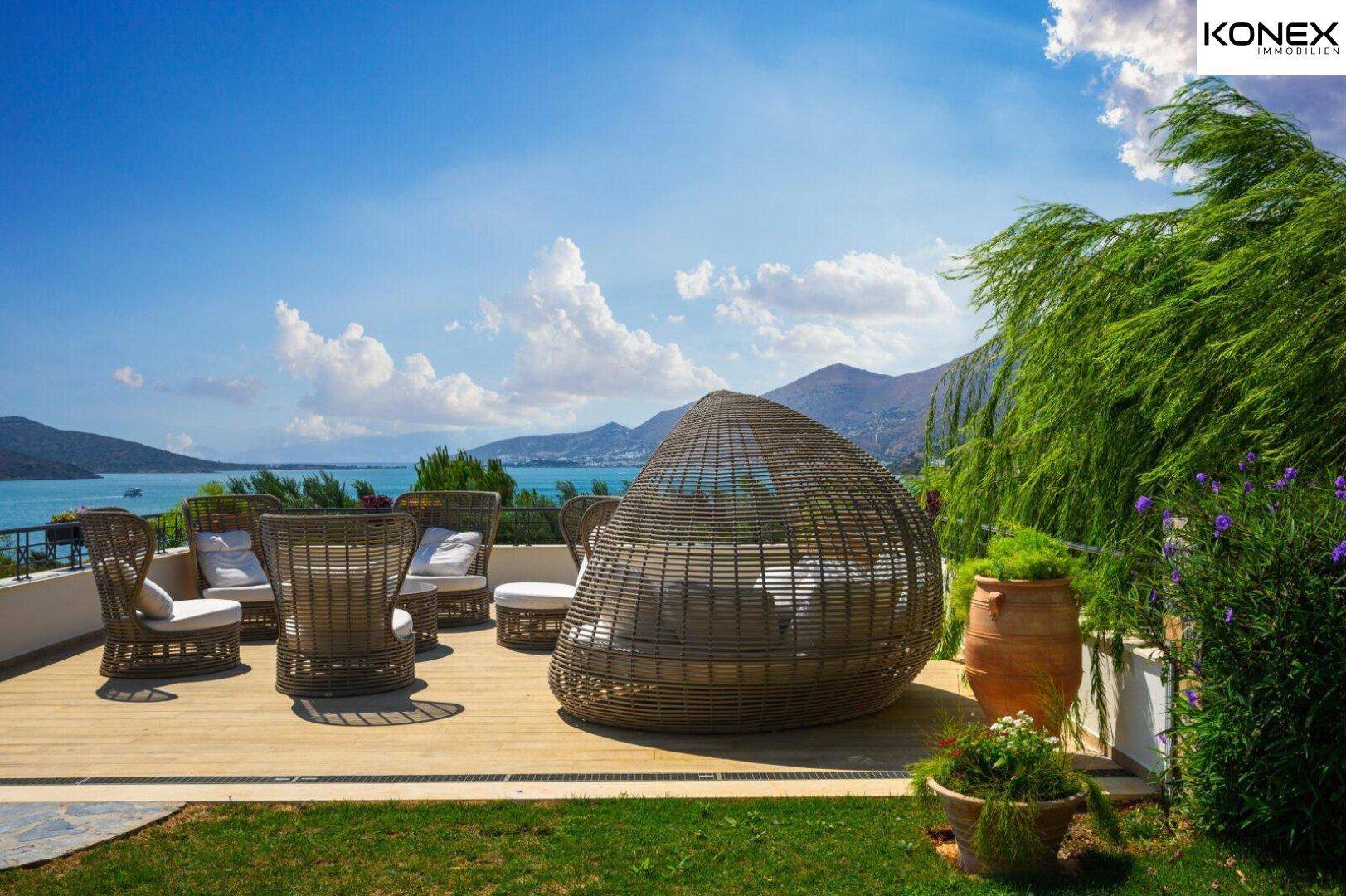 Sonnenterrasse mit bequemen Loungemöbeln und weitem Blick über das Meer und die Landschaft.
