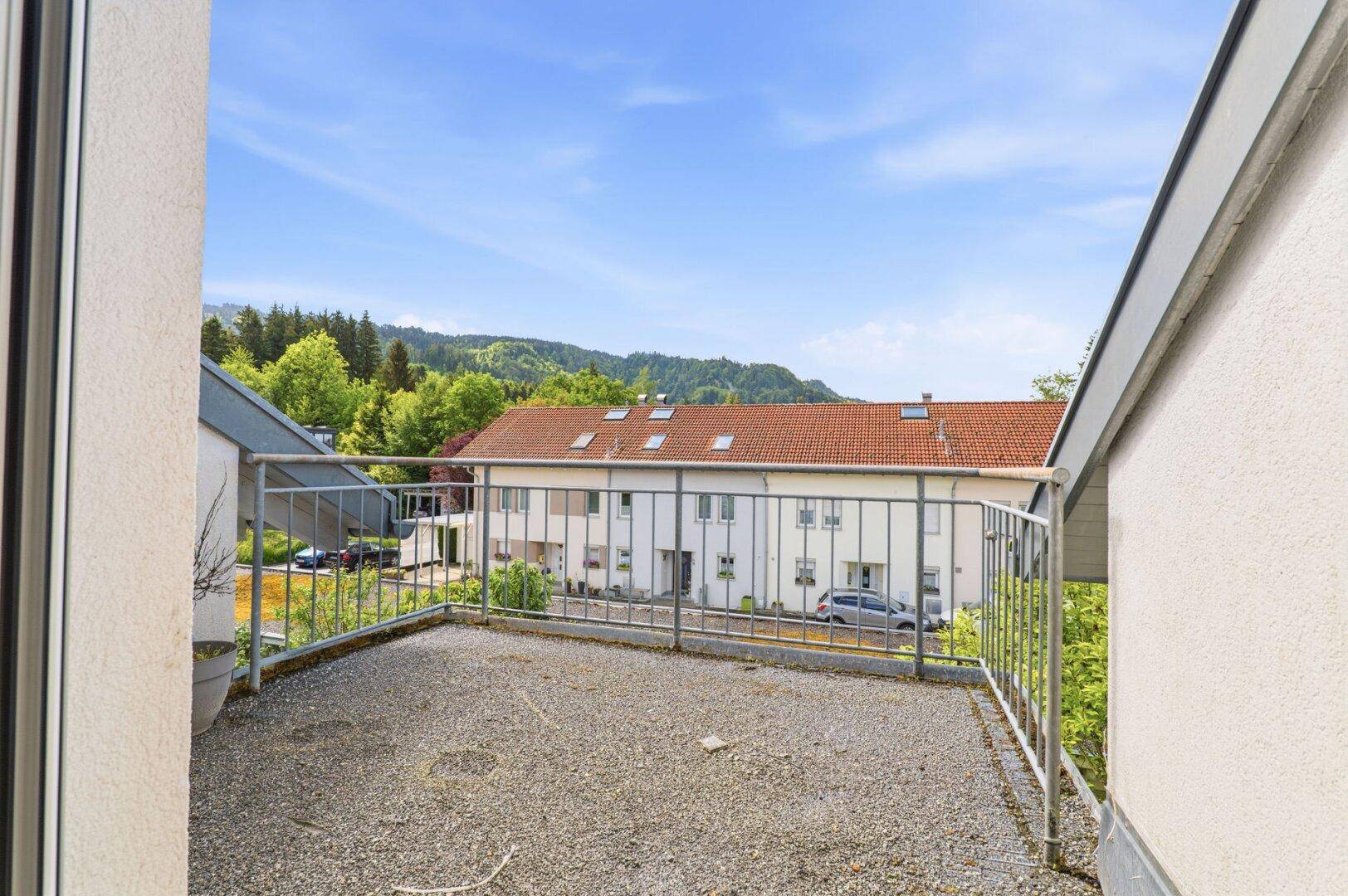 Geräumiger Balkon mit Metallgeländer und weitem Blick auf die Landschaft.