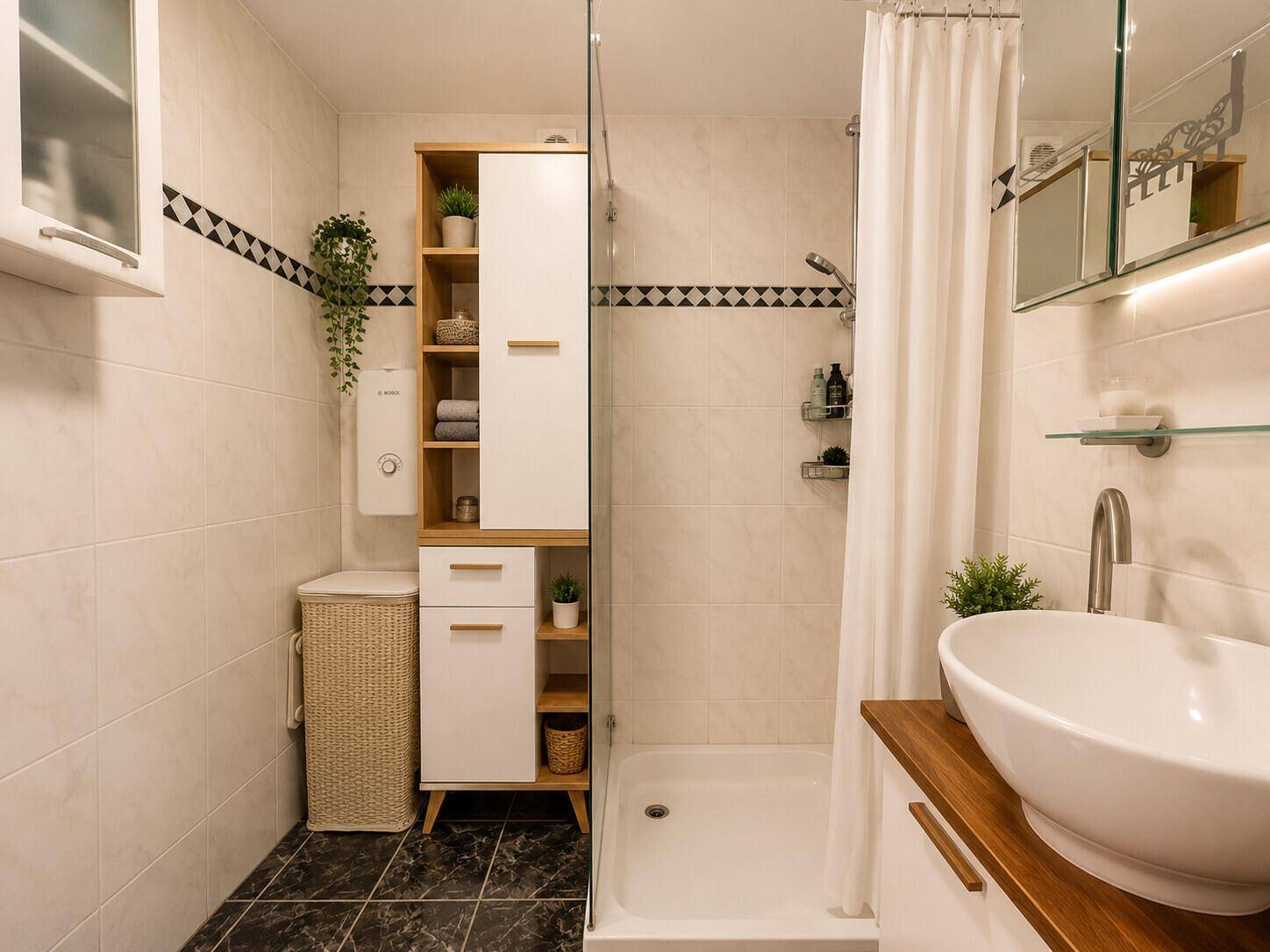 Modernes Badezimmer mit Duschbereich, Aufsatzwaschbecken und hellen Wand- und Bodenfliesen.