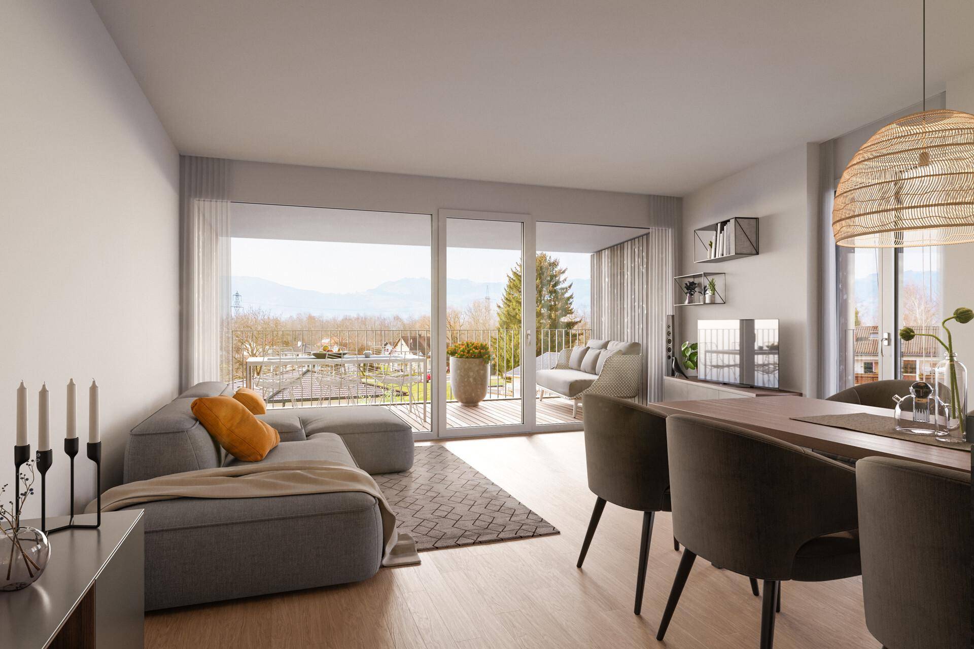 Helles Wohnzimmer mit großem Sofa, Essbereich und Zugang zu einem Balkon mit Bergblick.