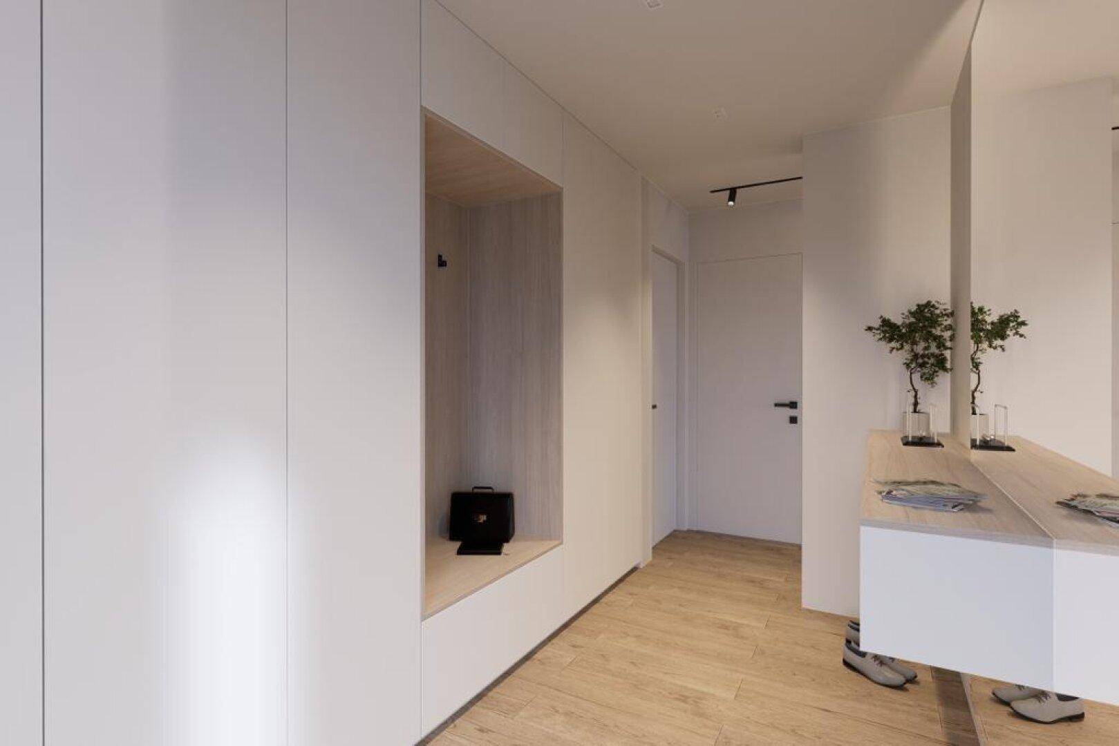 Heller Flur mit integrierter Garderobe, Holzboden und minimalistischem Design.