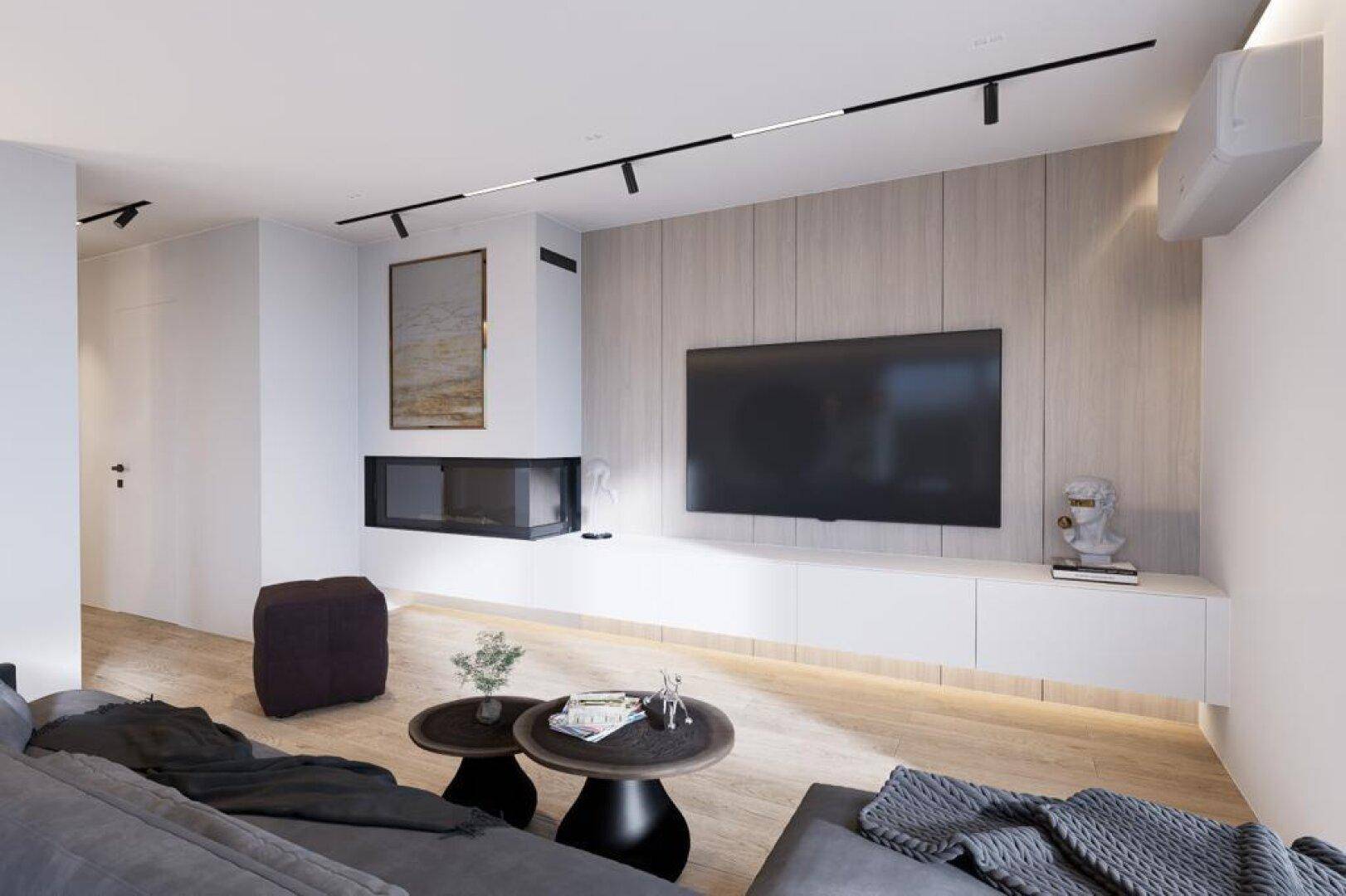 Moderner Wohnbereich mit Kamin, großem Fernseher und bequemen Sofas für entspannte Abende.