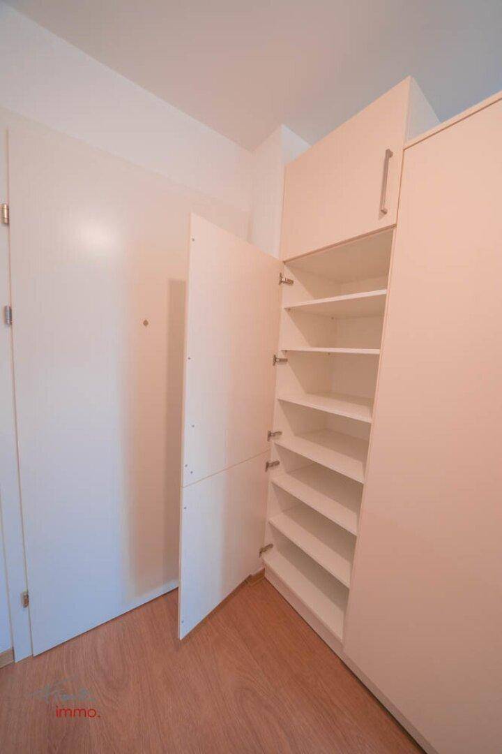 Flur mit praktischem Einbauschrank und hellem Holzboden, bietet viel Stauraum.