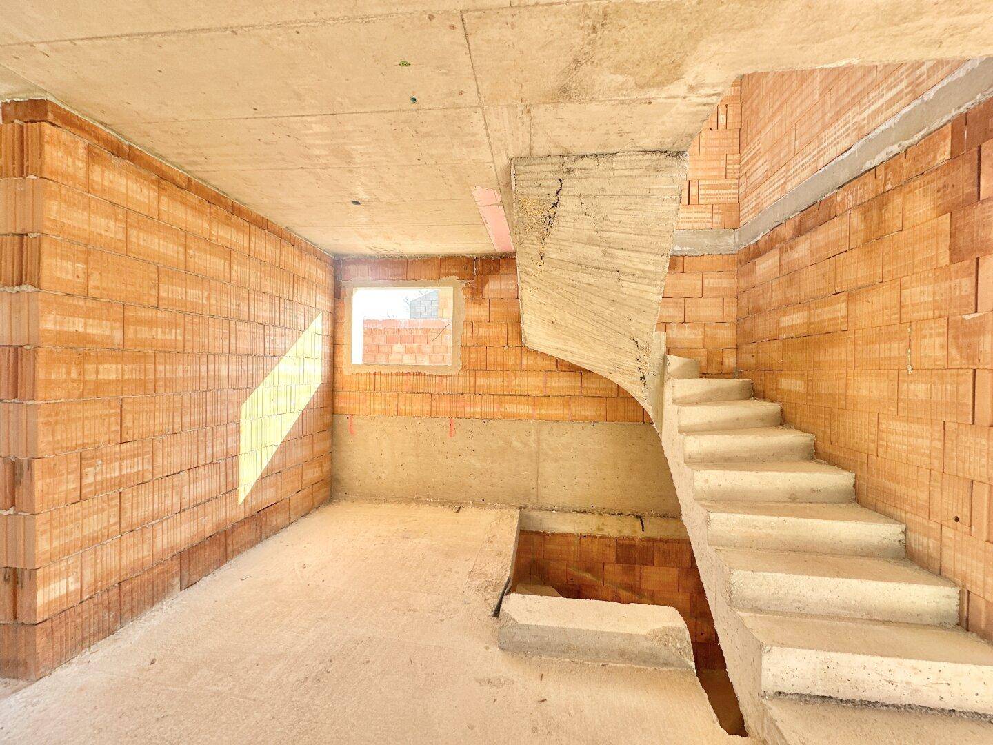 Detailansicht der Betontreppe im Rohbau, die in das obere Stockwerk führt.