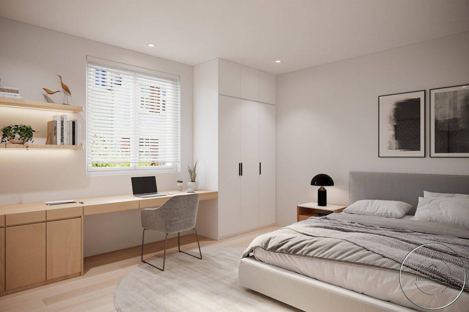 Helles Schlafzimmer mit Doppelbett, integriertem Schreibtisch unter dem Fenster und Einbauschränken.