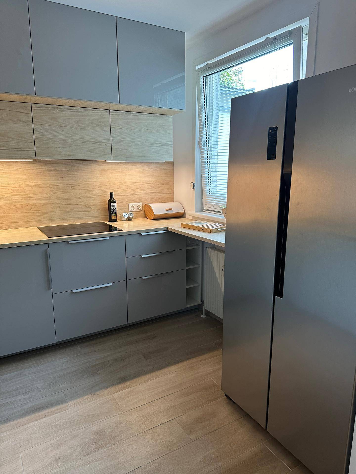Helle Küche mit Fenster, modernen Geräten und viel Arbeitsfläche für kulinarische Aktivitäten.