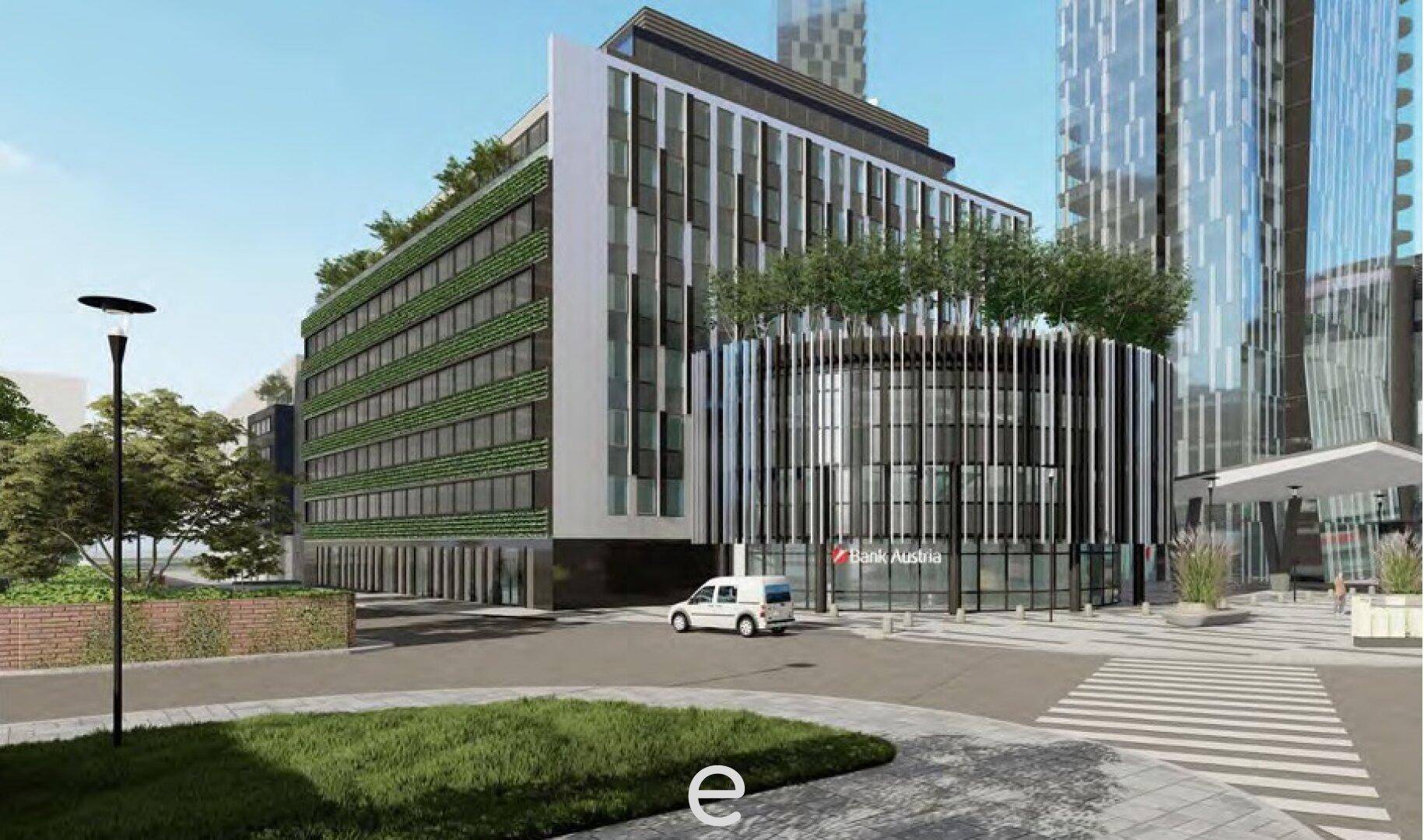 Modernes Geschäftsgebäude mit grüner Fassade und einer Bankfiliale im Erdgeschoss, umgeben von Grünflächen.