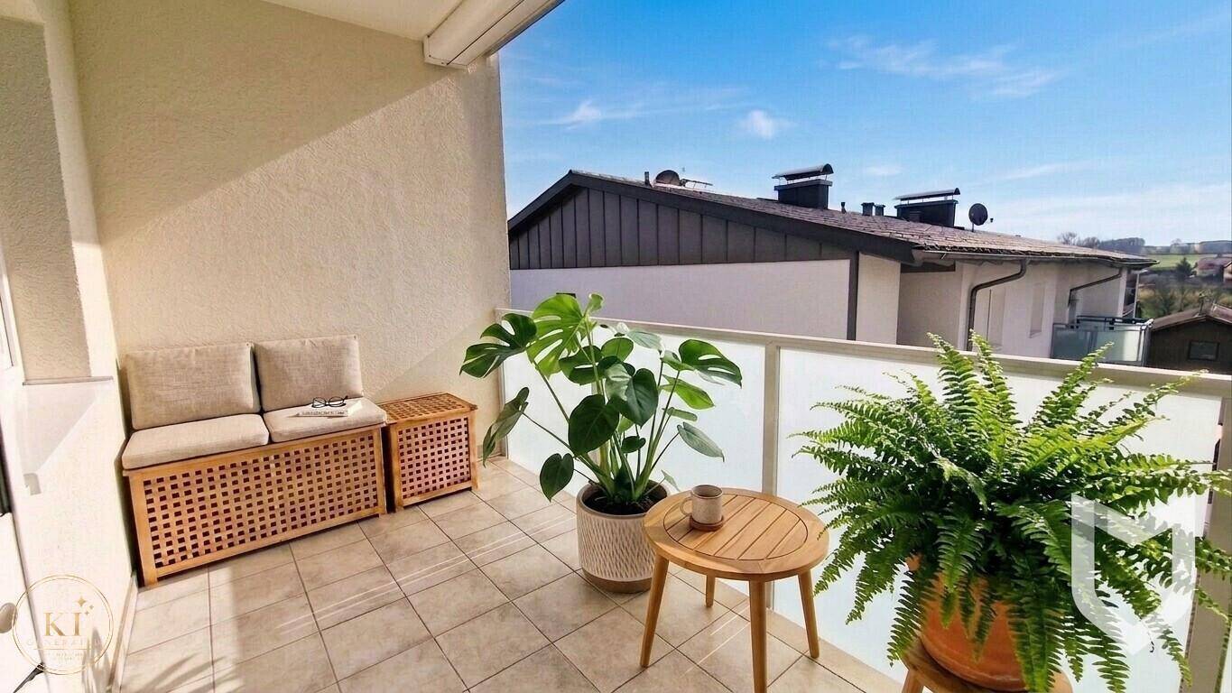 Gemütlicher Balkon mit Sitzgelegenheiten, Pflanzen und Blick auf die Umgebung.