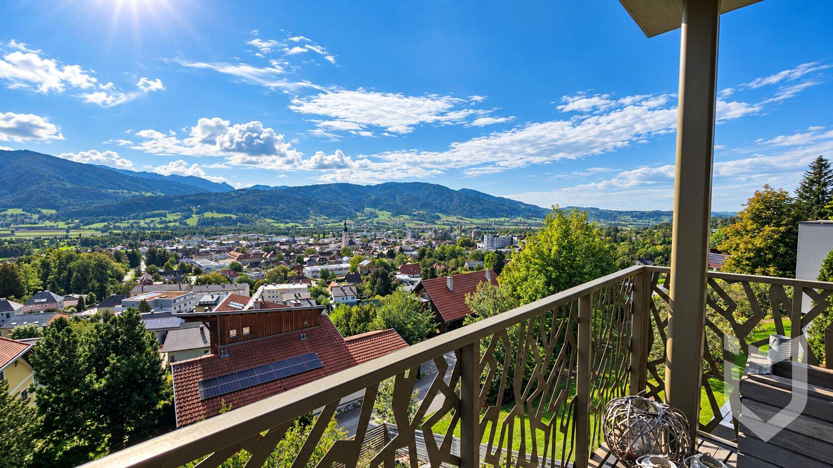 Balkon mit dekorativem Geländer und Panoramablick über die Stadt und die Berge.