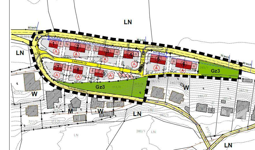 Übersichtsplan eines Baugebiets mit eingezeichneten Parzellen, Straßen und Grünflächen für neue Gebäude.