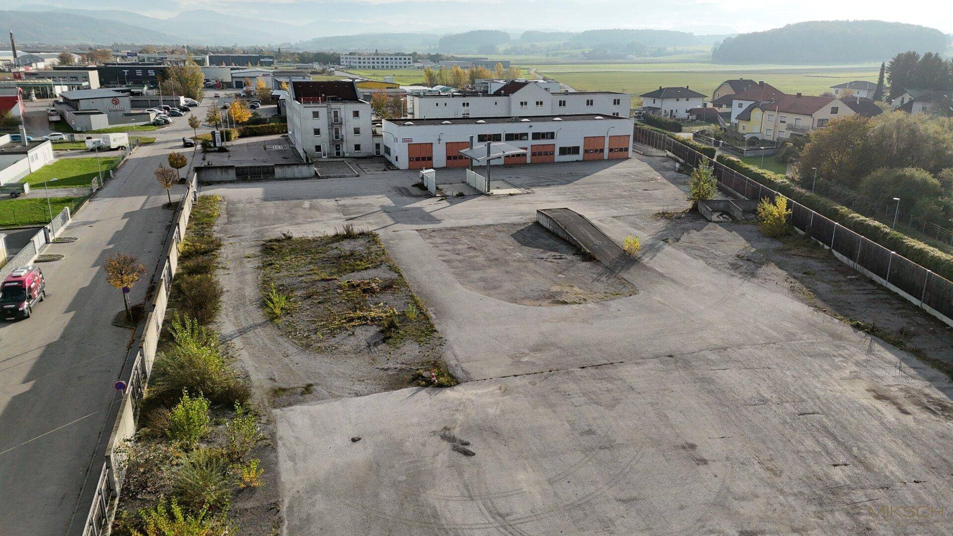 Luftaufnahme des gesamten Geschäftsgeländes mit weitläufigen Parkflächen und Zufahrtswegen.
