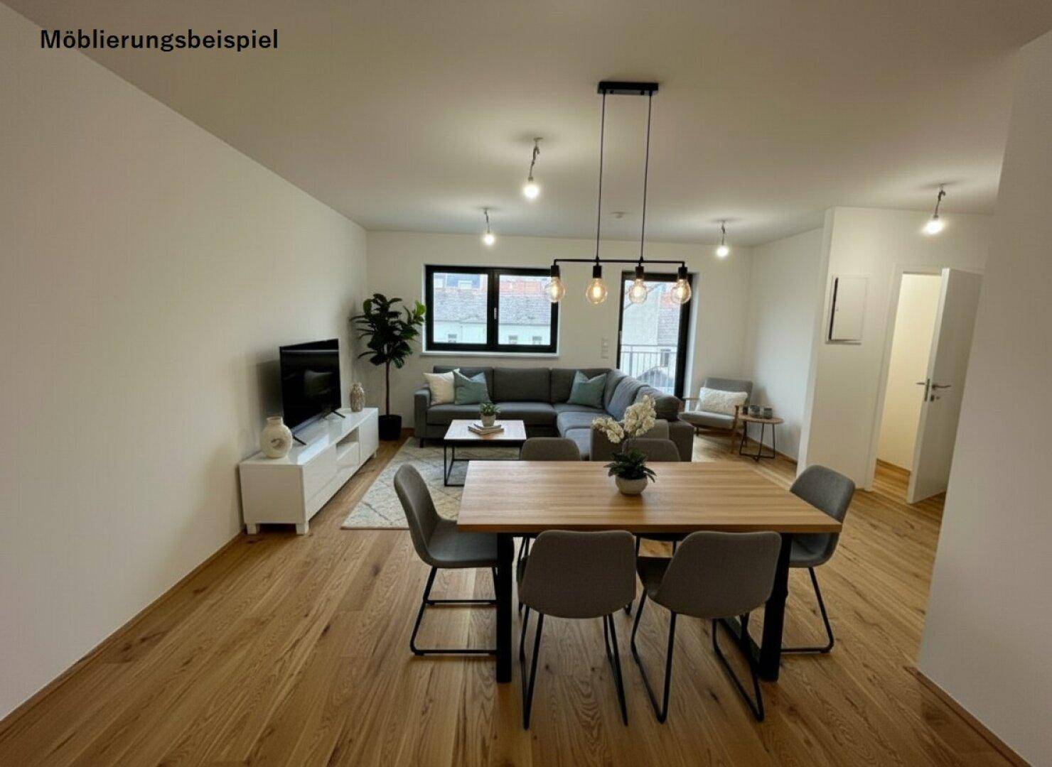 Möbliertes Wohn- und Esszimmer mit Holzboden, modernem Sofa und Esstisch, als Einrichtungsbeispiel.