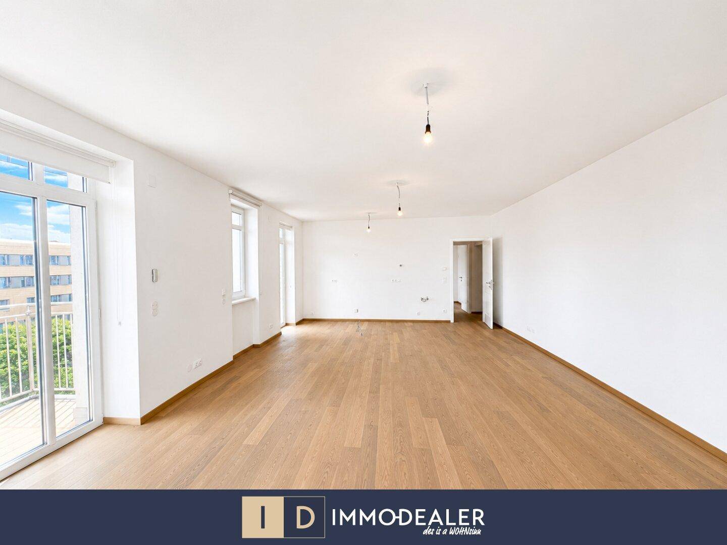 Großes, helles Zimmer mit Parkettboden und Zugang zu einem Balkon, ideal als Wohnbereich.