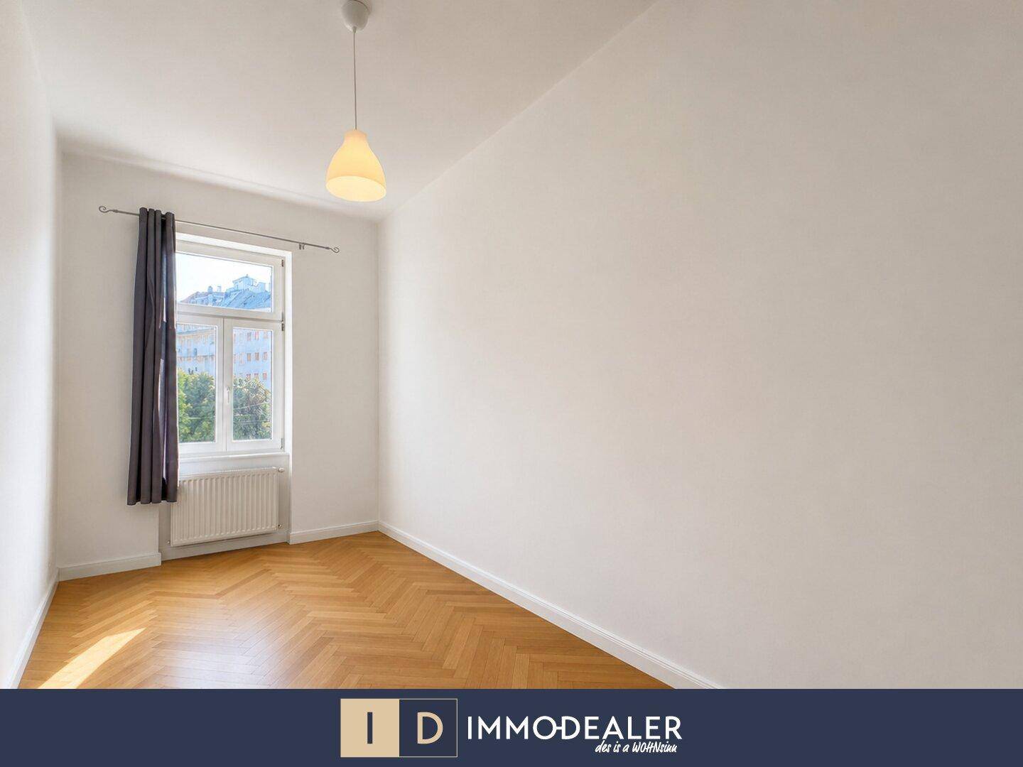 Ruhiges Schlafzimmer mit Fischgrätparkett und einem Fenster, das viel Licht spendet.