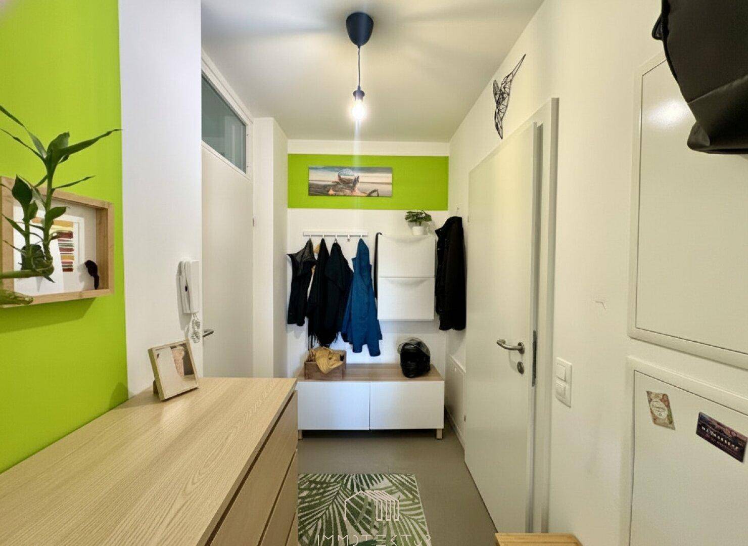 Moderner Flur mit Garderobe, Schuhschrank und heller, freundlicher Farbgestaltung.