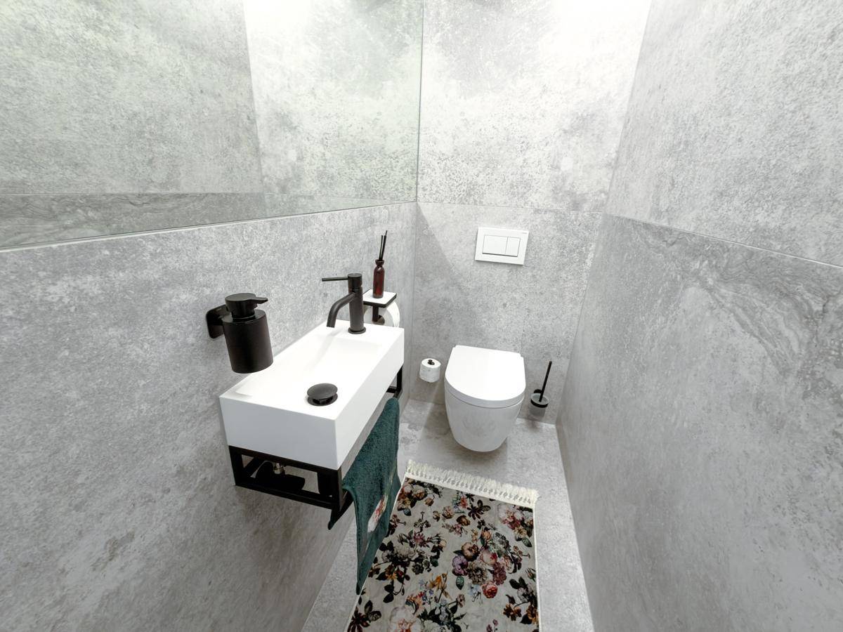 Kleines Gäste-WC mit modernen grauen Fliesen, wandhängendem WC und kompaktem Waschbecken.