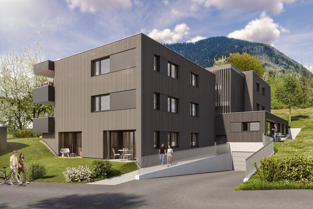 Moderne Architektur eines Wohngebäudes mit Holzfassade, Rampe und Bergblick.