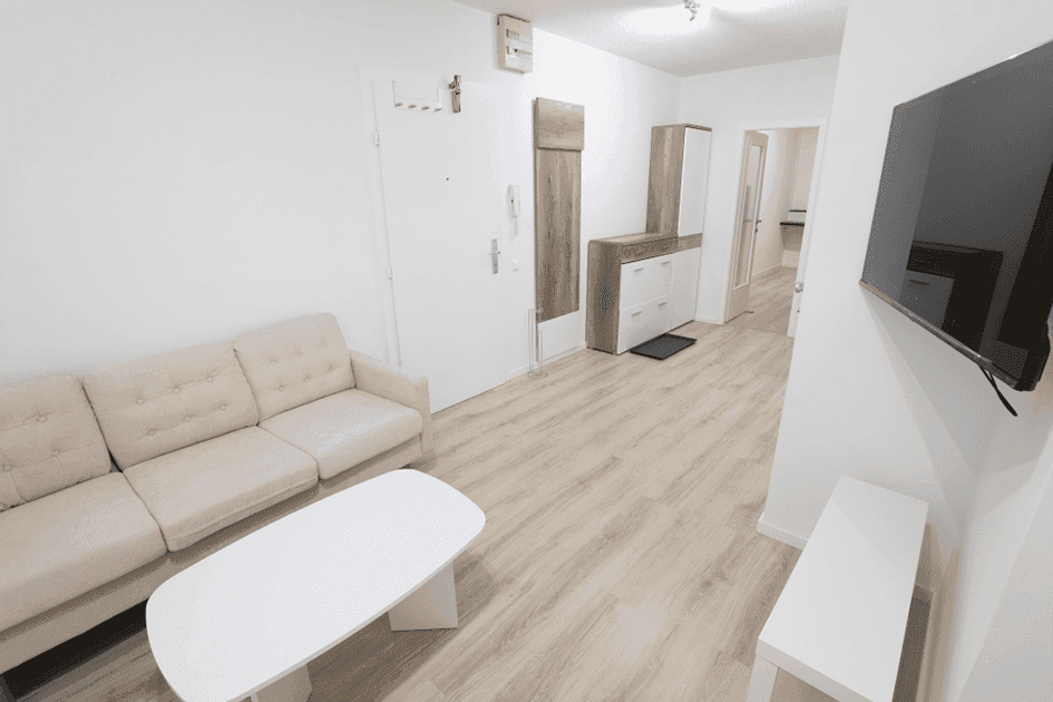 Heller Flur mit Garderobe, Kommode und Zugang zu weiteren Räumen.