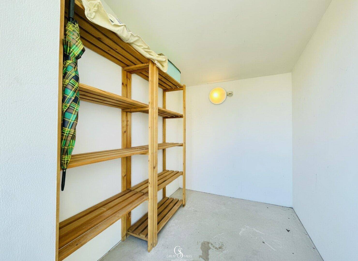 Einfacher Abstellraum mit Holzregalen und ausreichend Platz für Lagerung.
