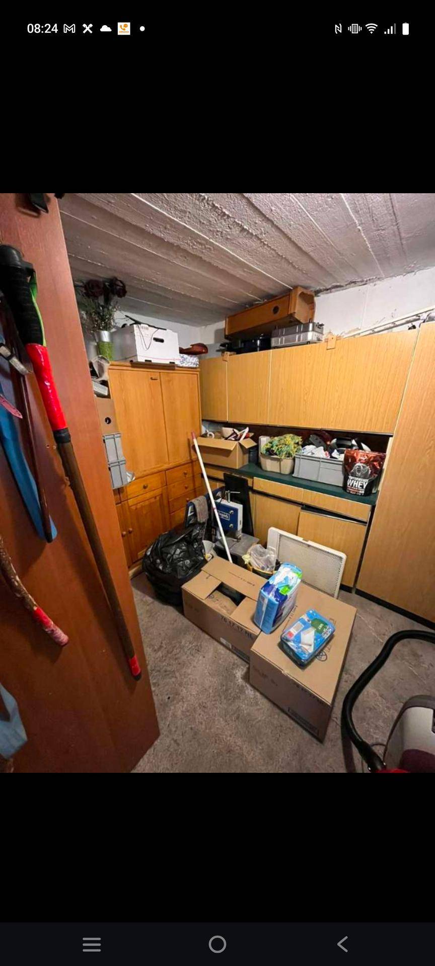 Praktischer Hauswirtschaftsraum mit Holzschränken und viel Stauraum für Haushaltsgegenstände.
