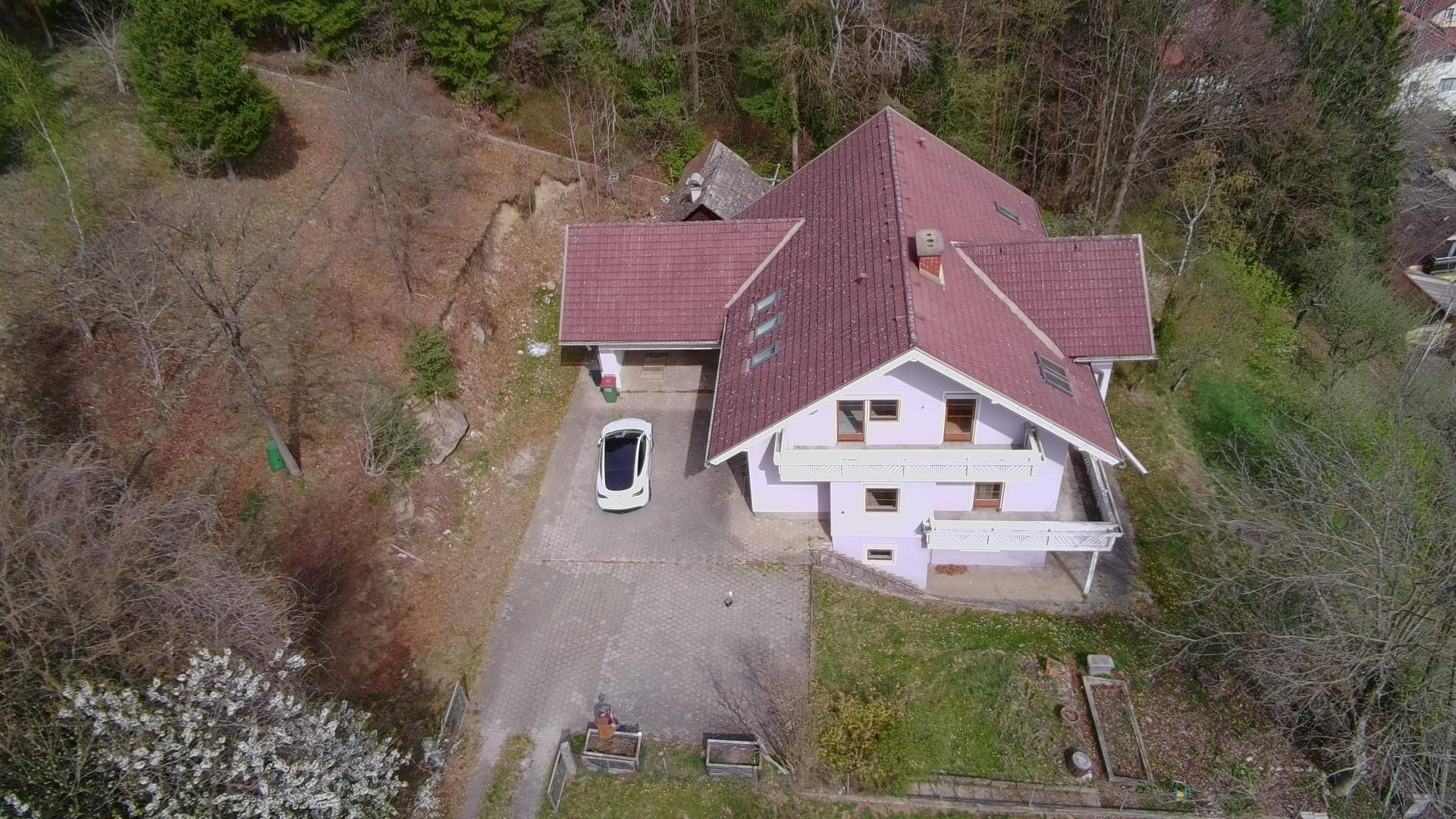 Luftaufnahme des Hauses mit rotem Ziegeldach und umliegender Natur.