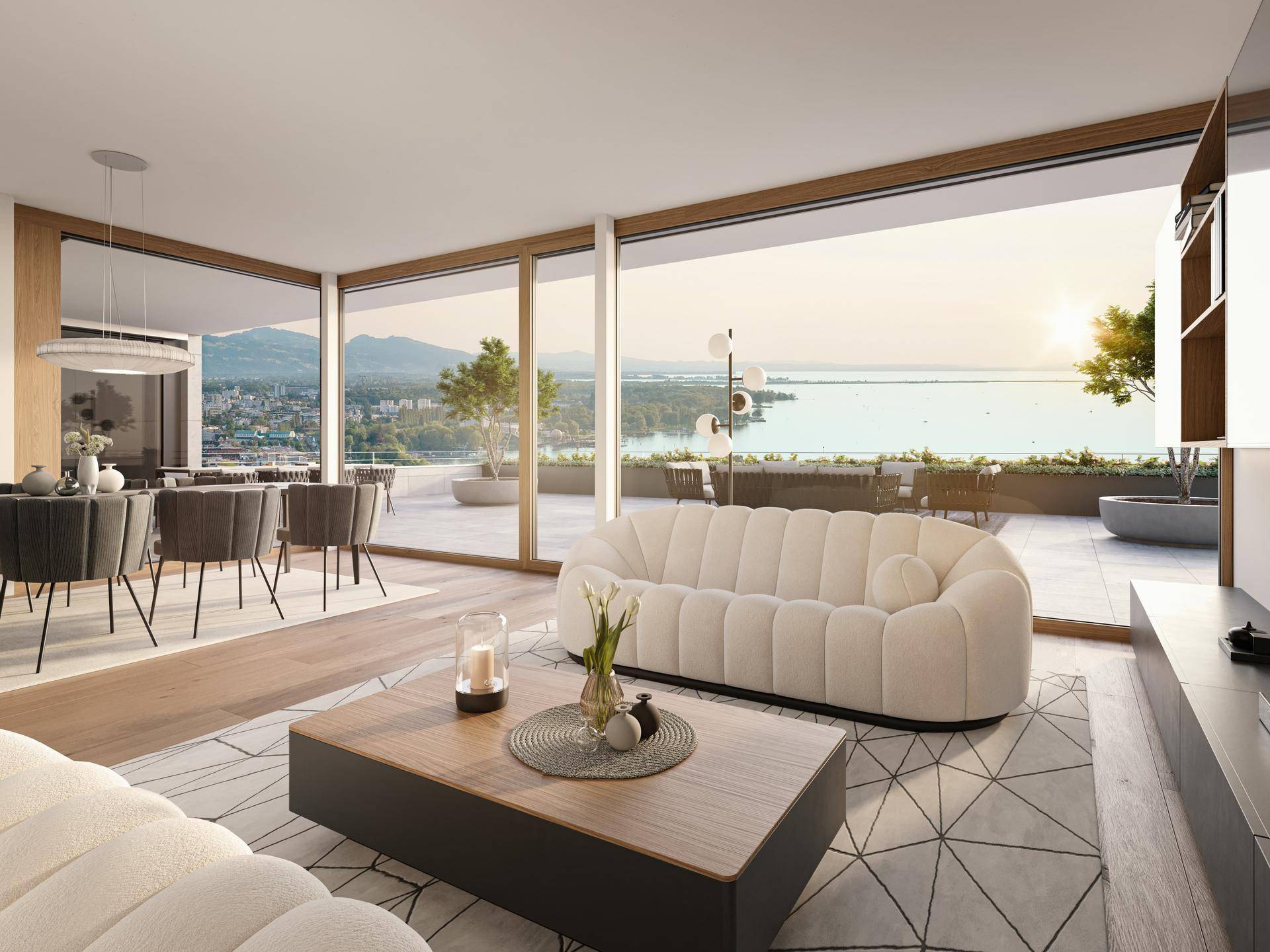 Heller Wohn-Essbereich mit großen Fenstern, modernem Sofa und Seeblick auf die Terrasse.