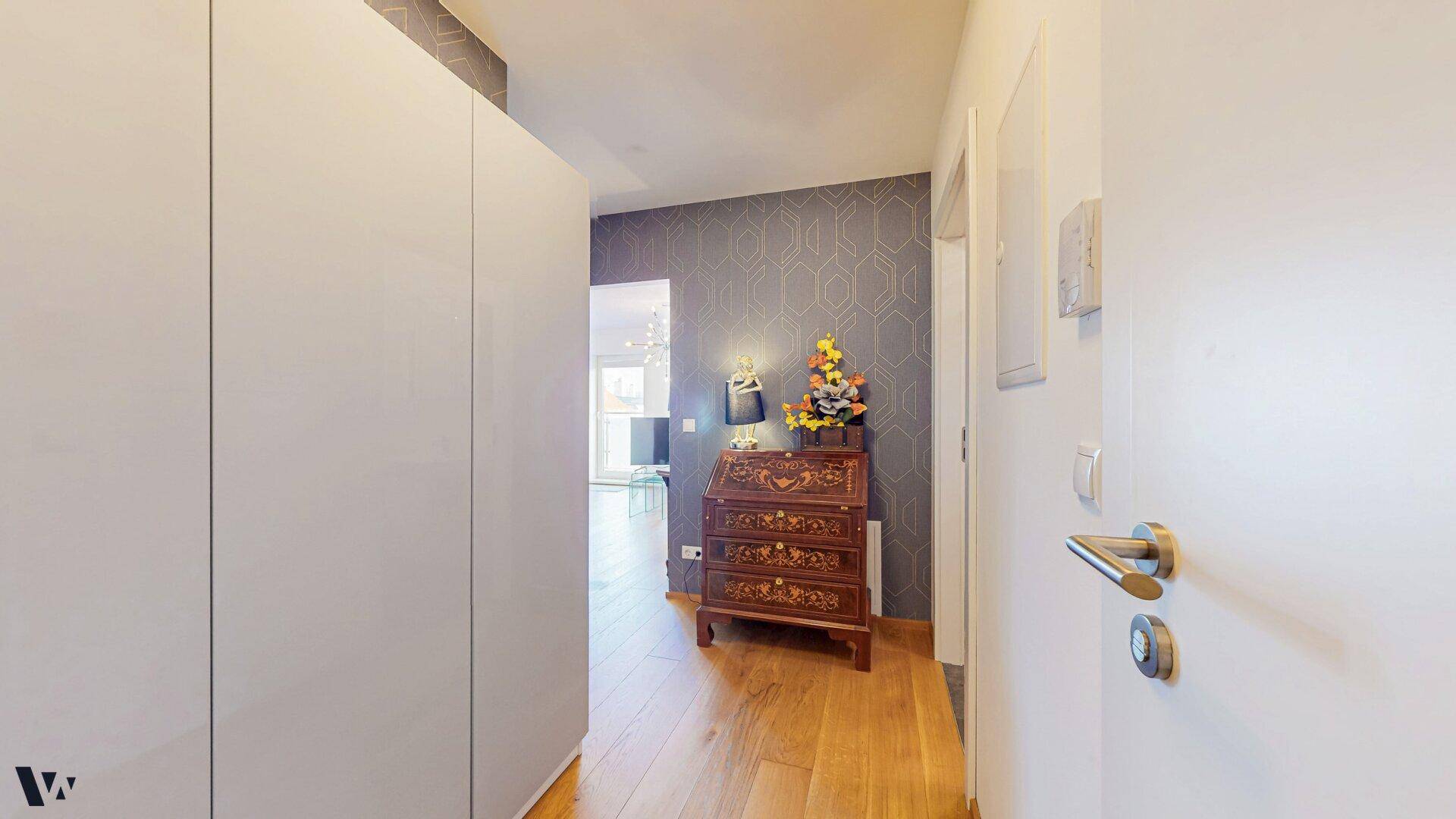 Eingangsbereich mit praktischem Einbauschrank und Holzboden, führt in den Wohnbereich.