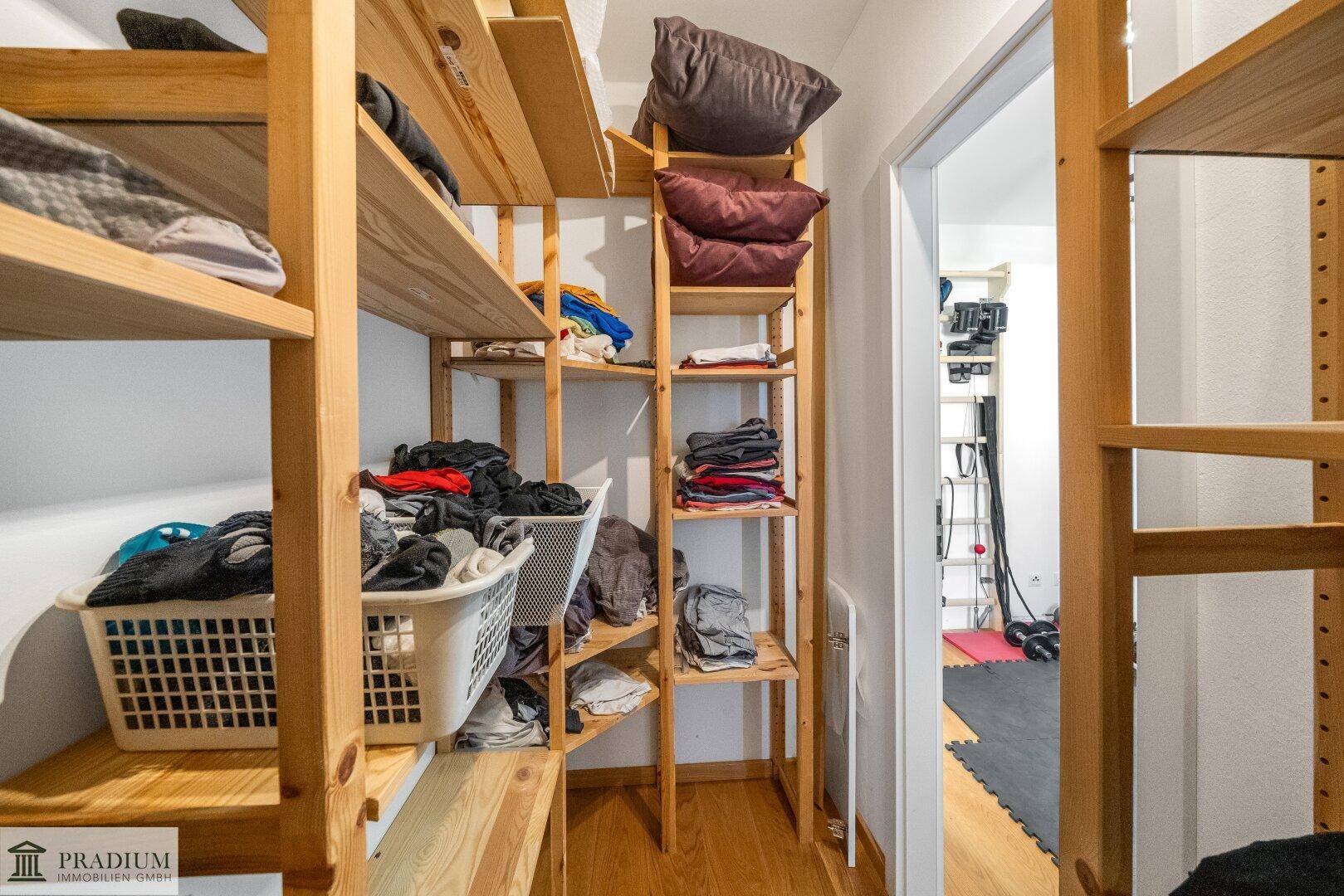 Praktischer Abstellraum mit maßgefertigten Holzregalen für optimale Aufbewahrungsmöglichkeiten.