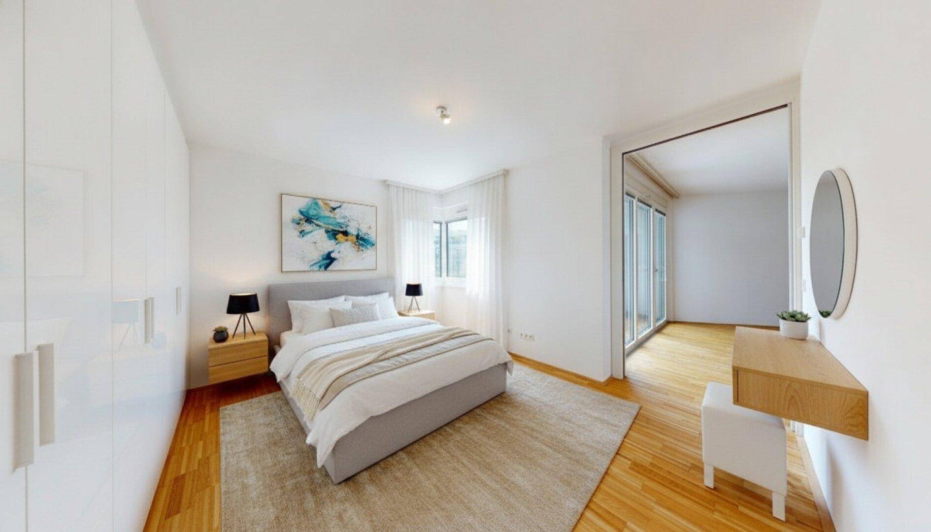 Helles Schlafzimmer mit modernem Bett, großem Kleiderschrank und Zugang zu einem weiteren Raum.