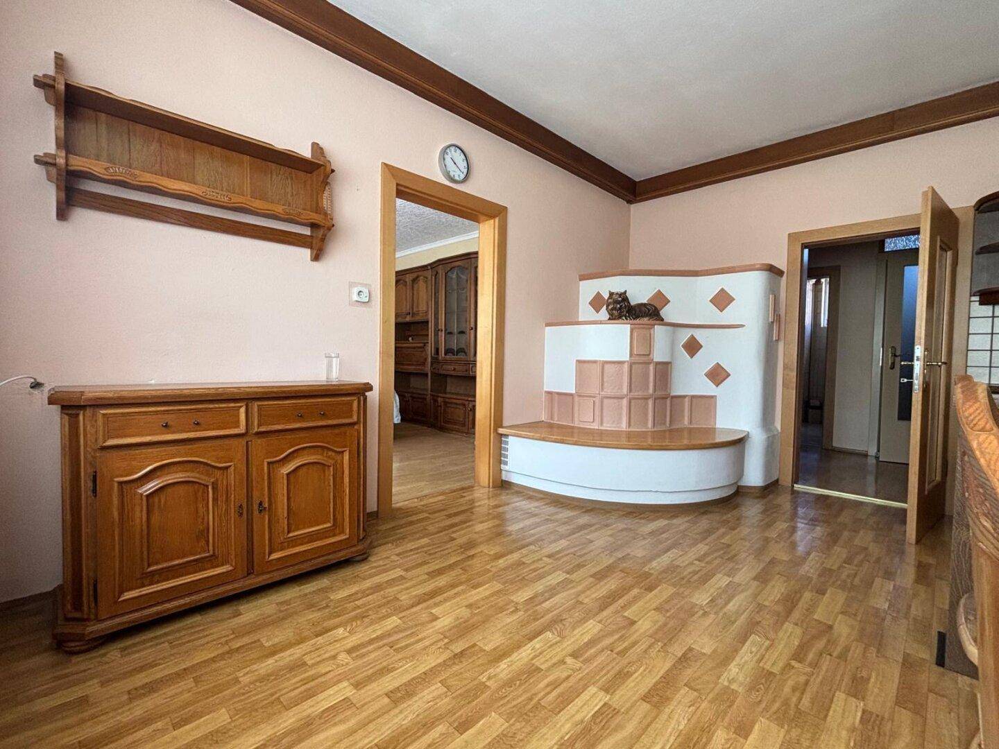 Gemütliches Wohnzimmer mit traditionellem Kachelofen und Holzmöbeln.
