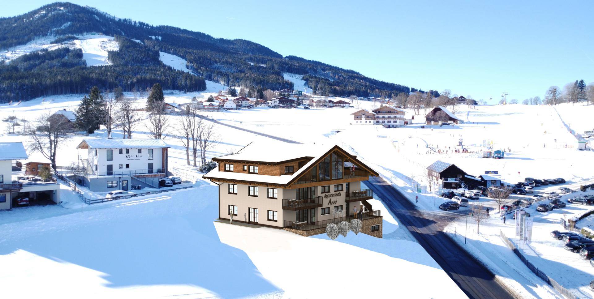 Luftaufnahme der Visualisierung des Apartmenthauses in einer weiten, verschneiten Winterlandschaft mit umliegenden Gebäuden.